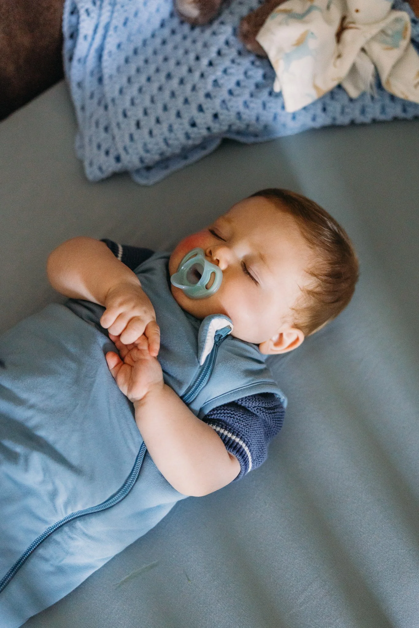 Baby sleeping in crib in sleep sack