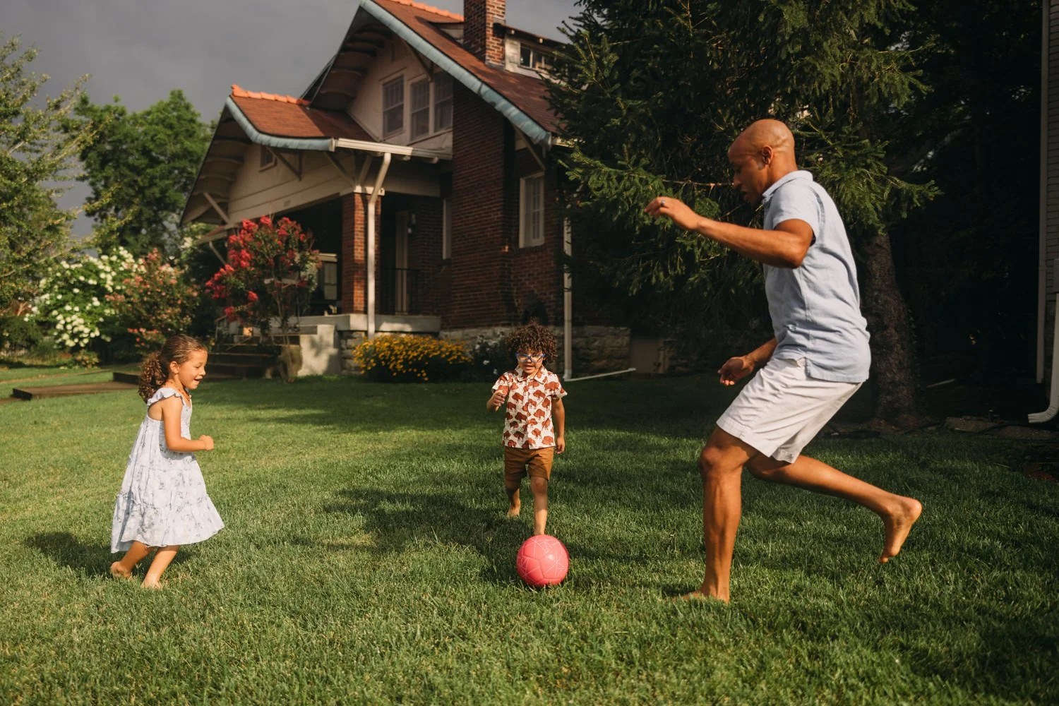 Family plays soccer for photos at home