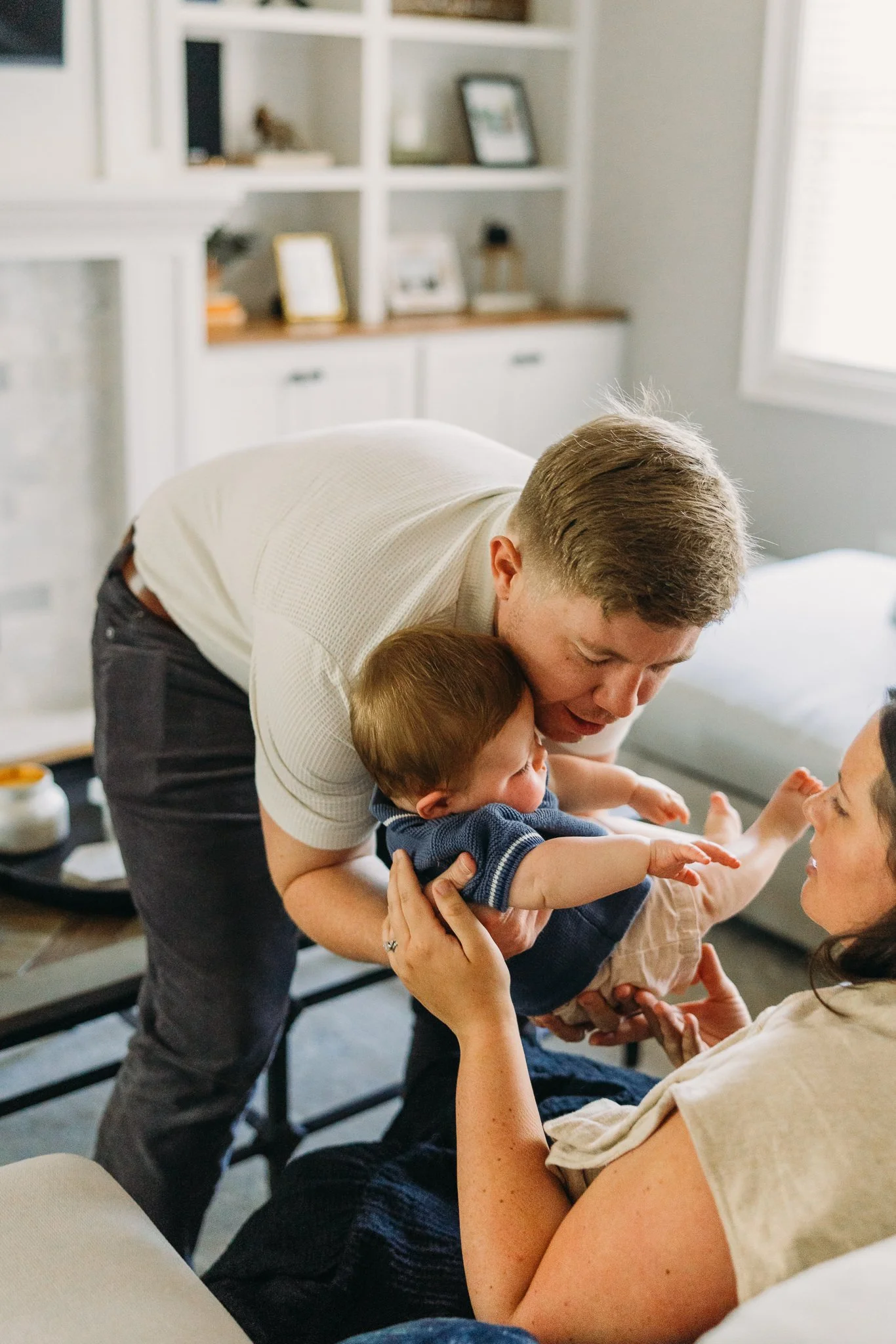 Dad putting baby down for a nap at photo session