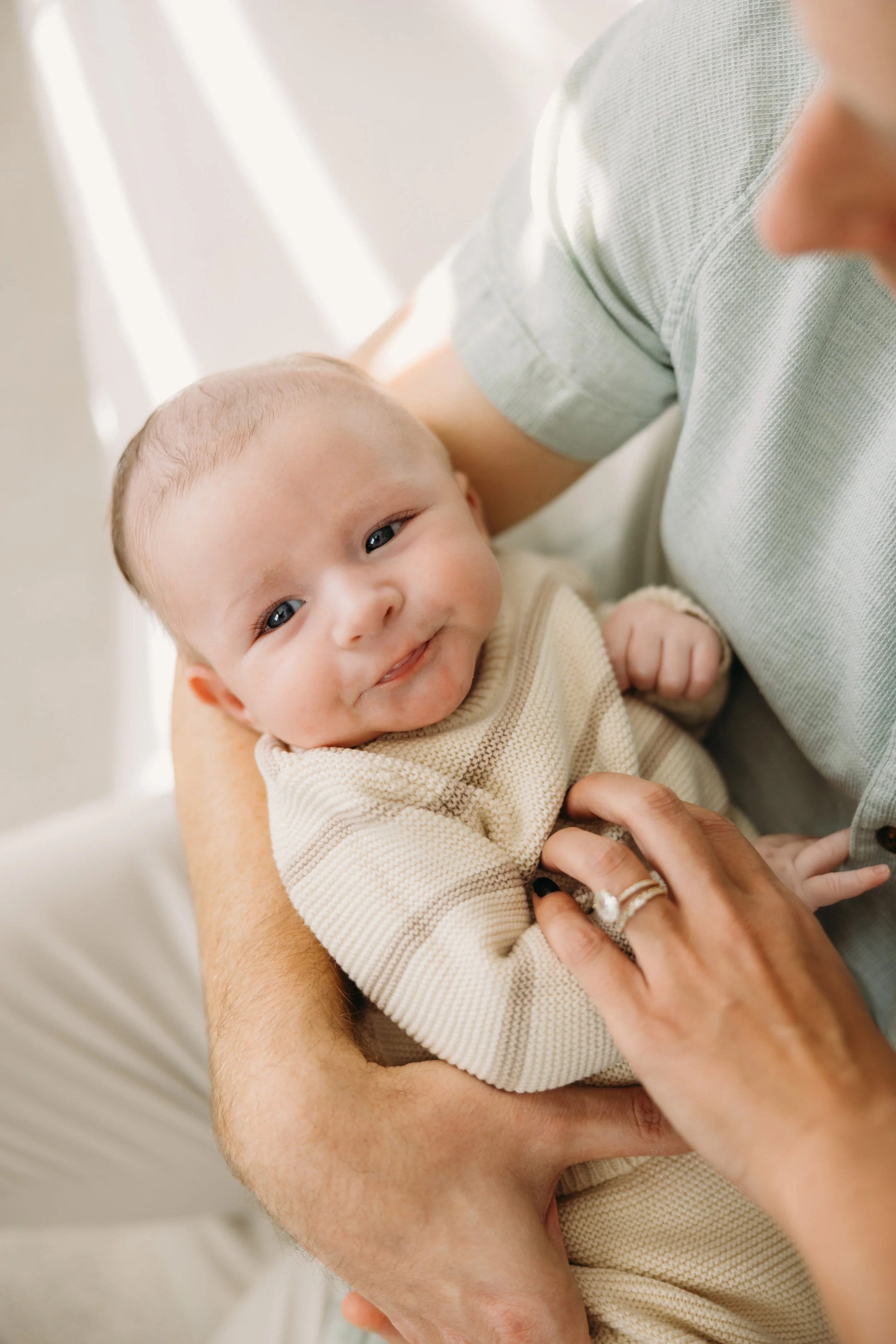 Father holding his newborn during an in-home newborn session in Nashville