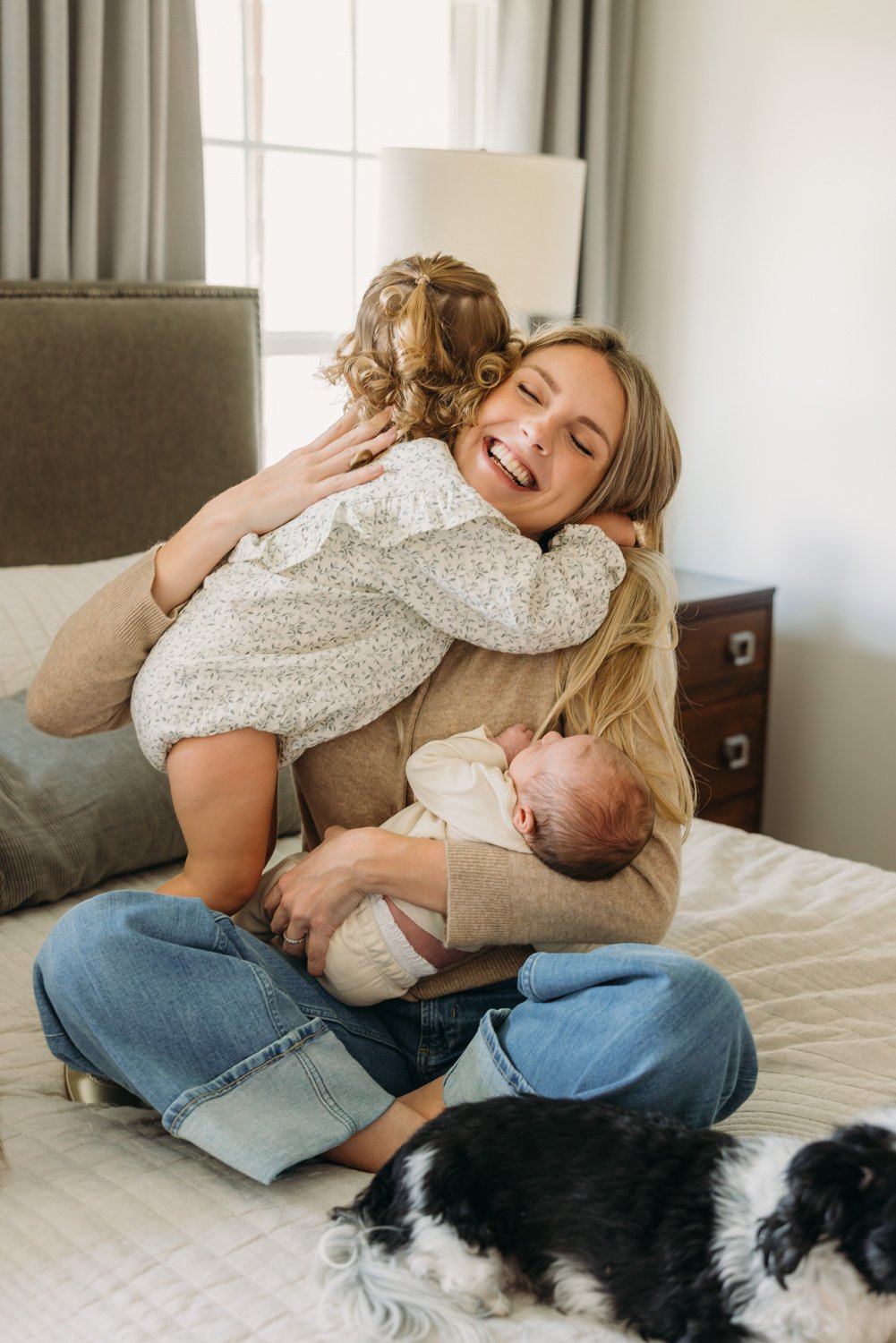 Nashville newborn photographer capturing a relaxed in-home family moment with mother, newborn, and sibling