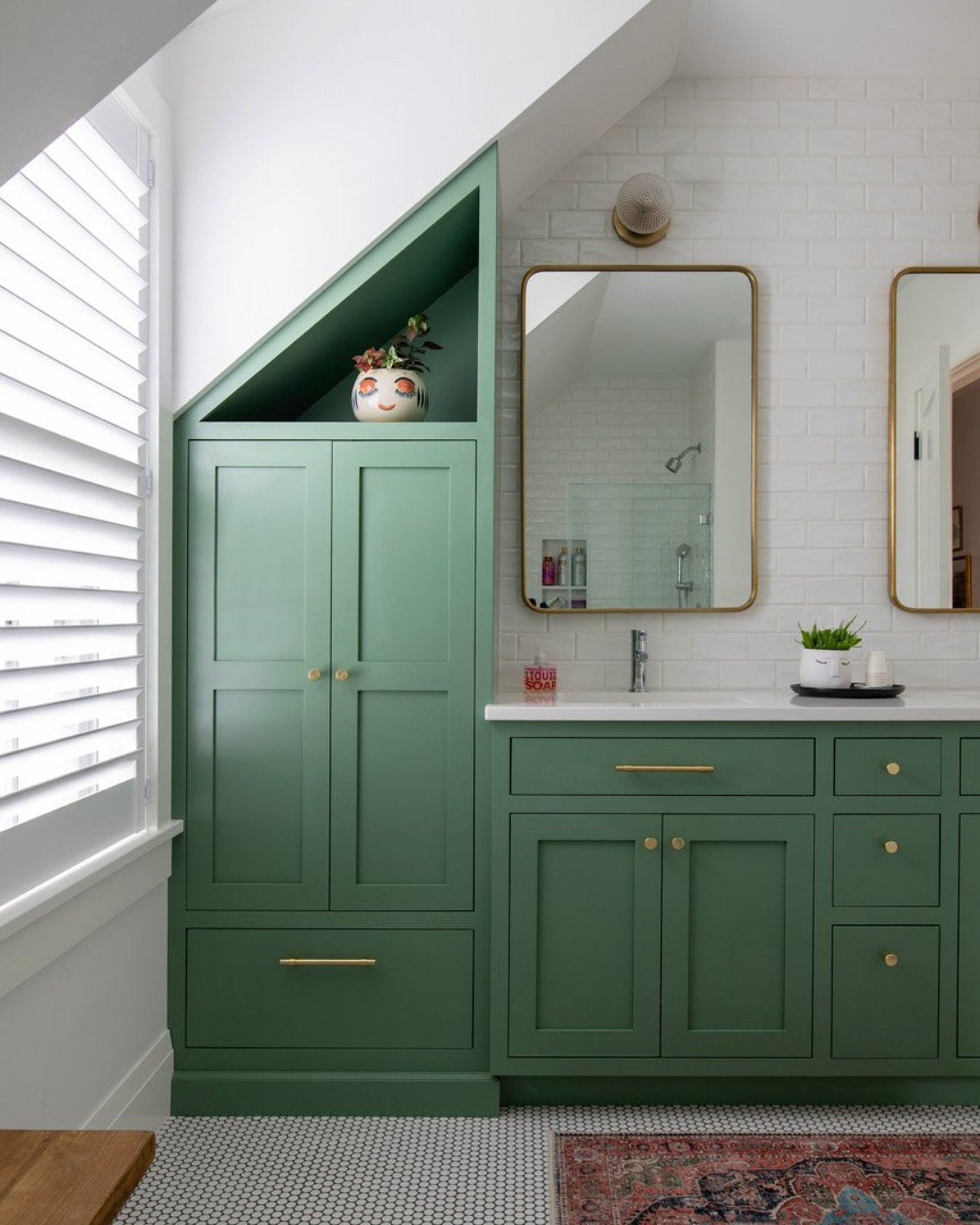 Proof that a vanity can steal the show. This custom linen tower and vanity by @weathervanewoodworking is bold and brings fresh energy to this kid&rsquo;s hall bathroom 💚 Balancing rich color with a timeless design, the homeowner selected classic til