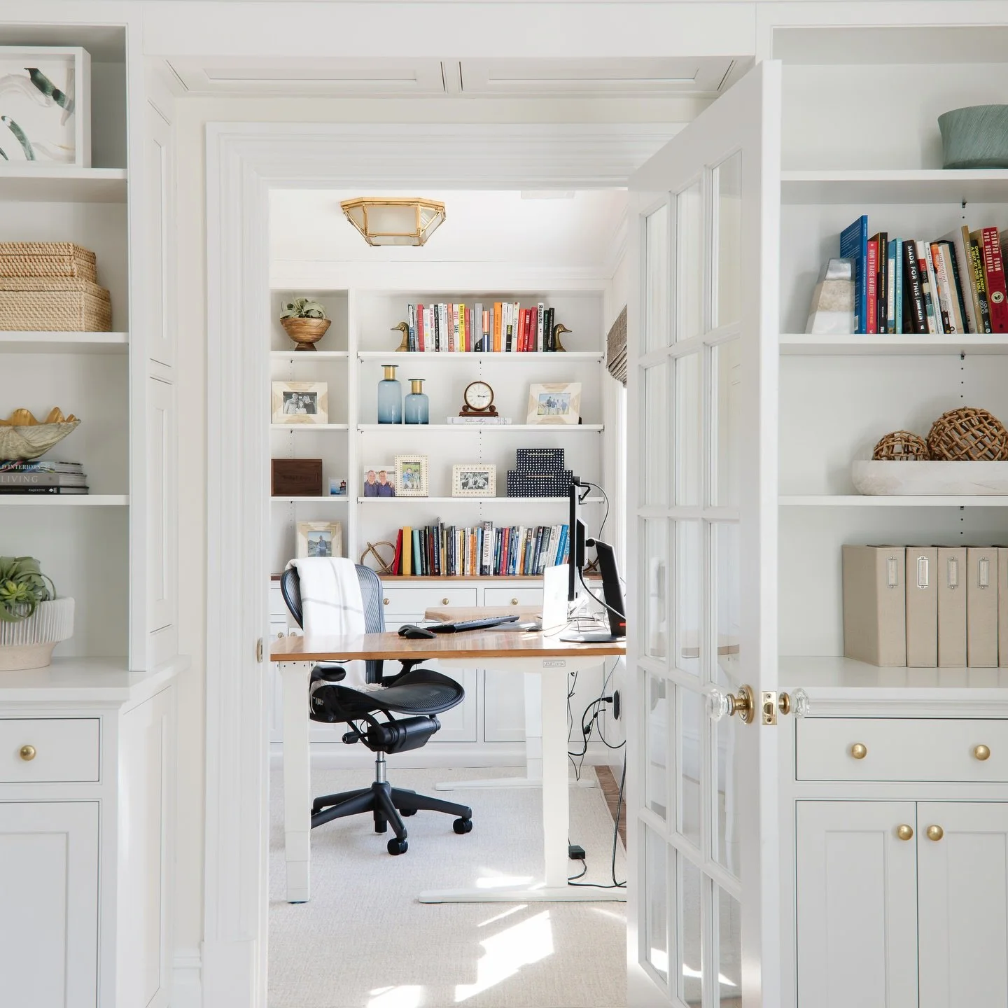 ✨This custom office space is all about clean design, smart storage, and natural light. Built-in shelving keeps everything organized (and looking good), while the glass doors add just enough separation without closing the space off.
.
It&rsquo;s simpl