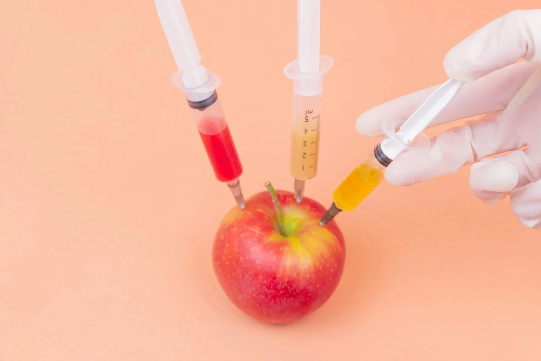 Acupuncture treatment with acupuncture needles inserted into a patient's back while a practitioner holds an herbal medicine stick.