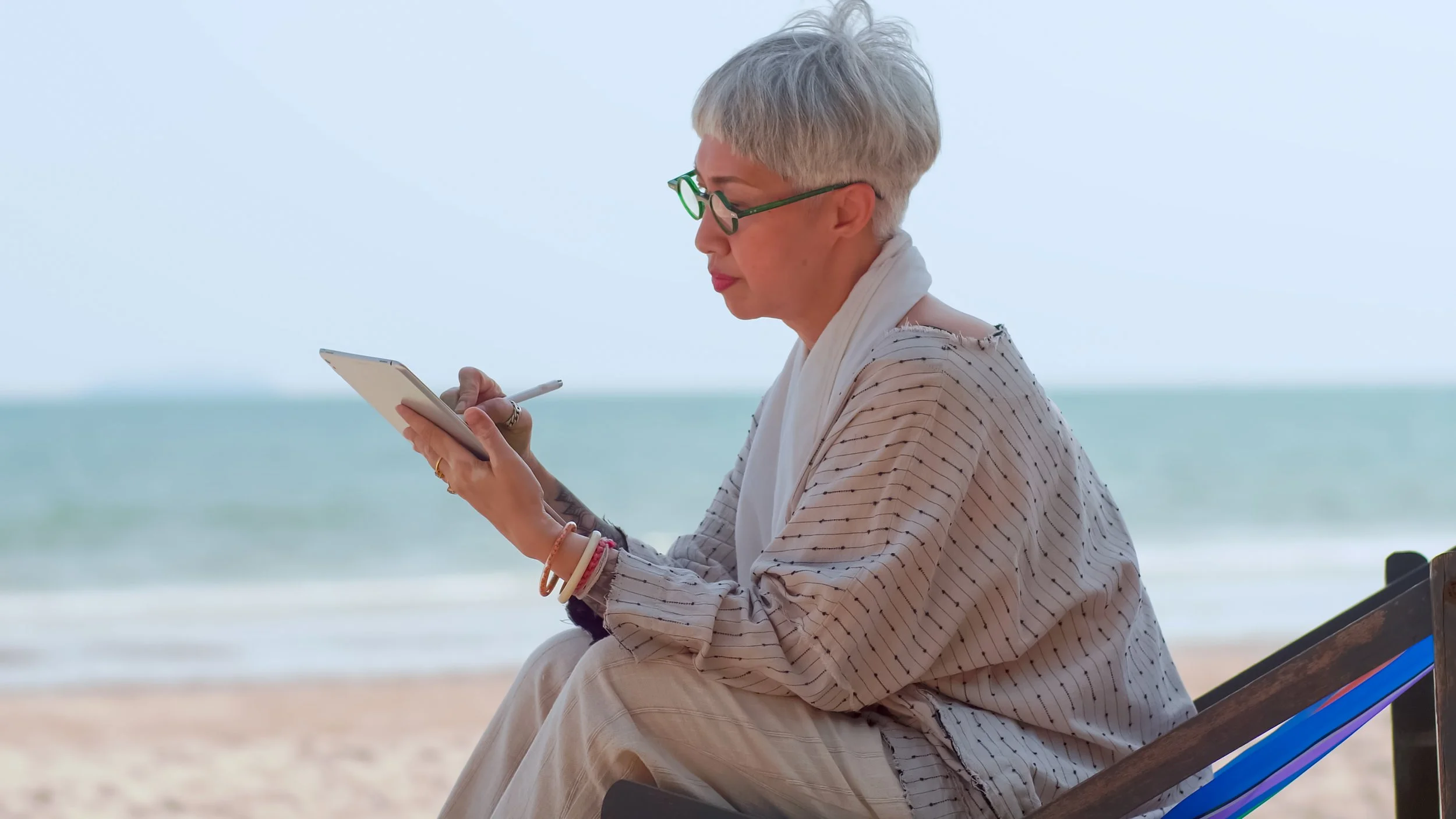vecteezy_asian-elderly-woman-using-a-tablet-computer-while-sitting-on_11095680.JPG