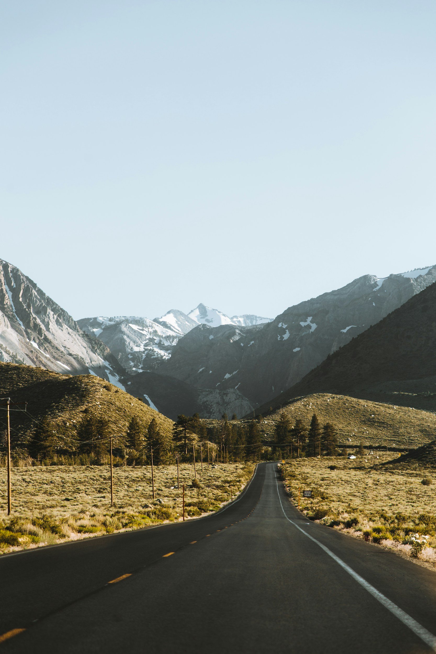 Mountains with an empty road leading to it, adventuring awaiting ahead.