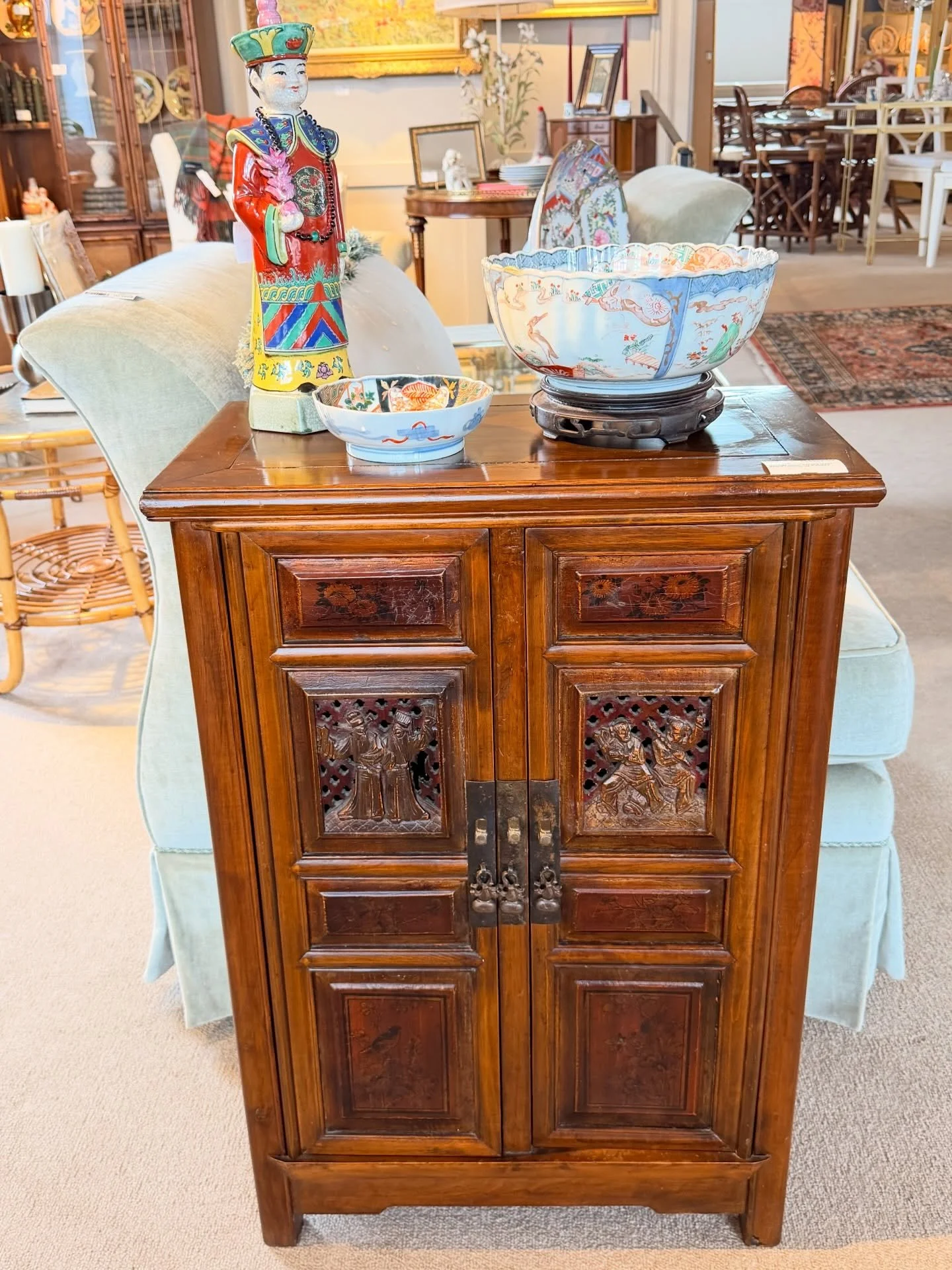 We love this small Asian carved huali wood cabinet!
It&rsquo;s such a great size. It&rsquo;s paneled on 3 sides and the back is finished so it could free stand. The front of the cabinet has 2 carved panels and 6 hand painted panels. The two doors ope