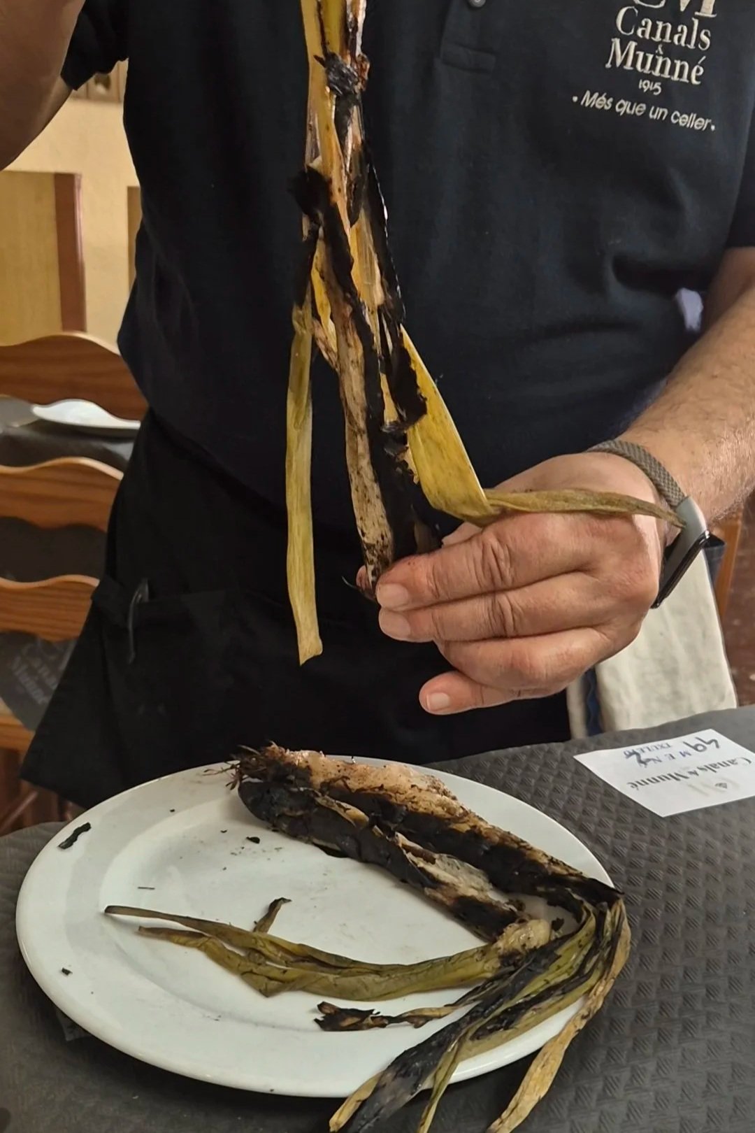 Spanish Calcots. Calçots are a type of green onion. It is a bit like a cross between a spring onion and a leek. They are served grilled with romesco sauce. Eating calçots is not just a meal, it's an event.