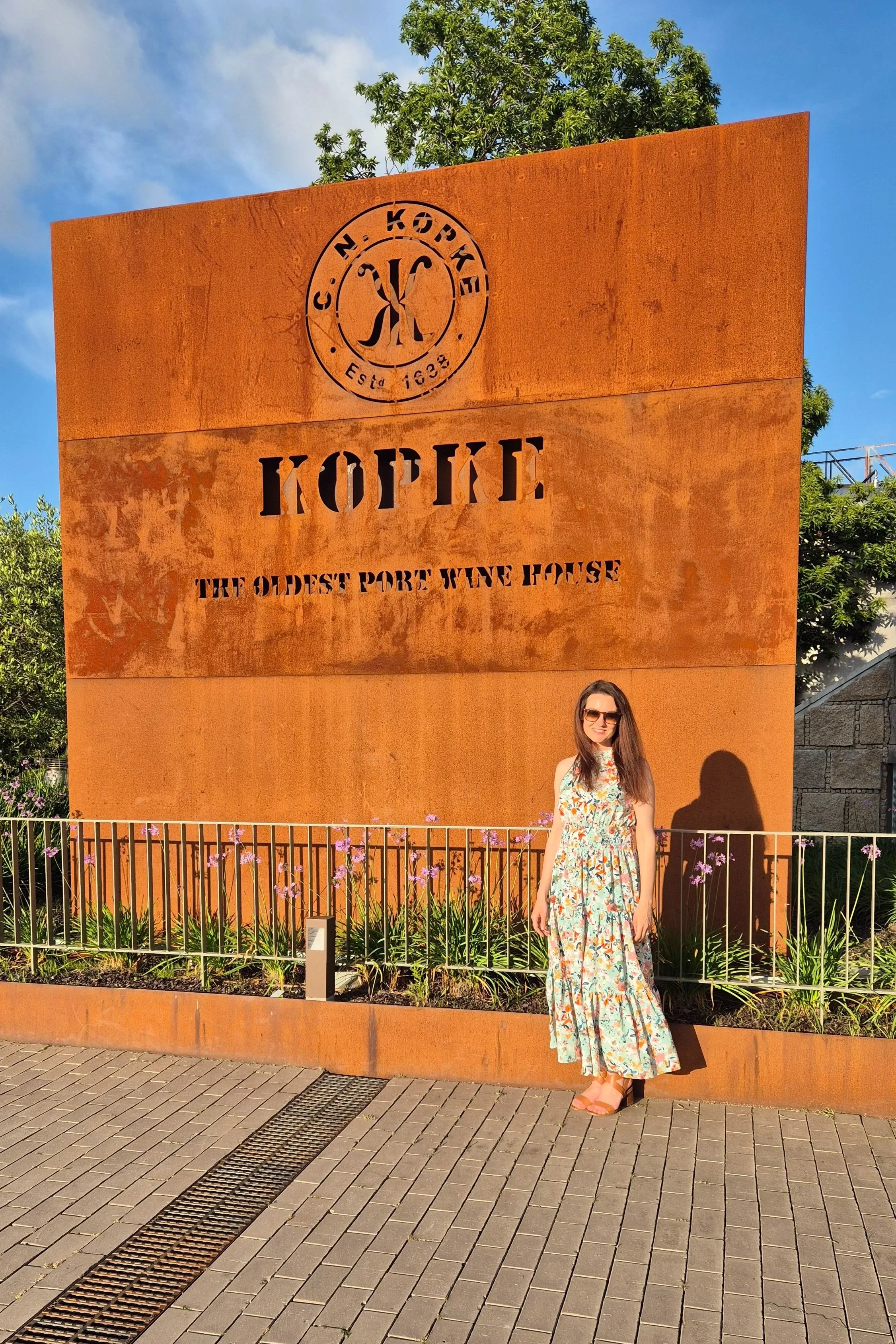 Woman in green dress standing at Kopke