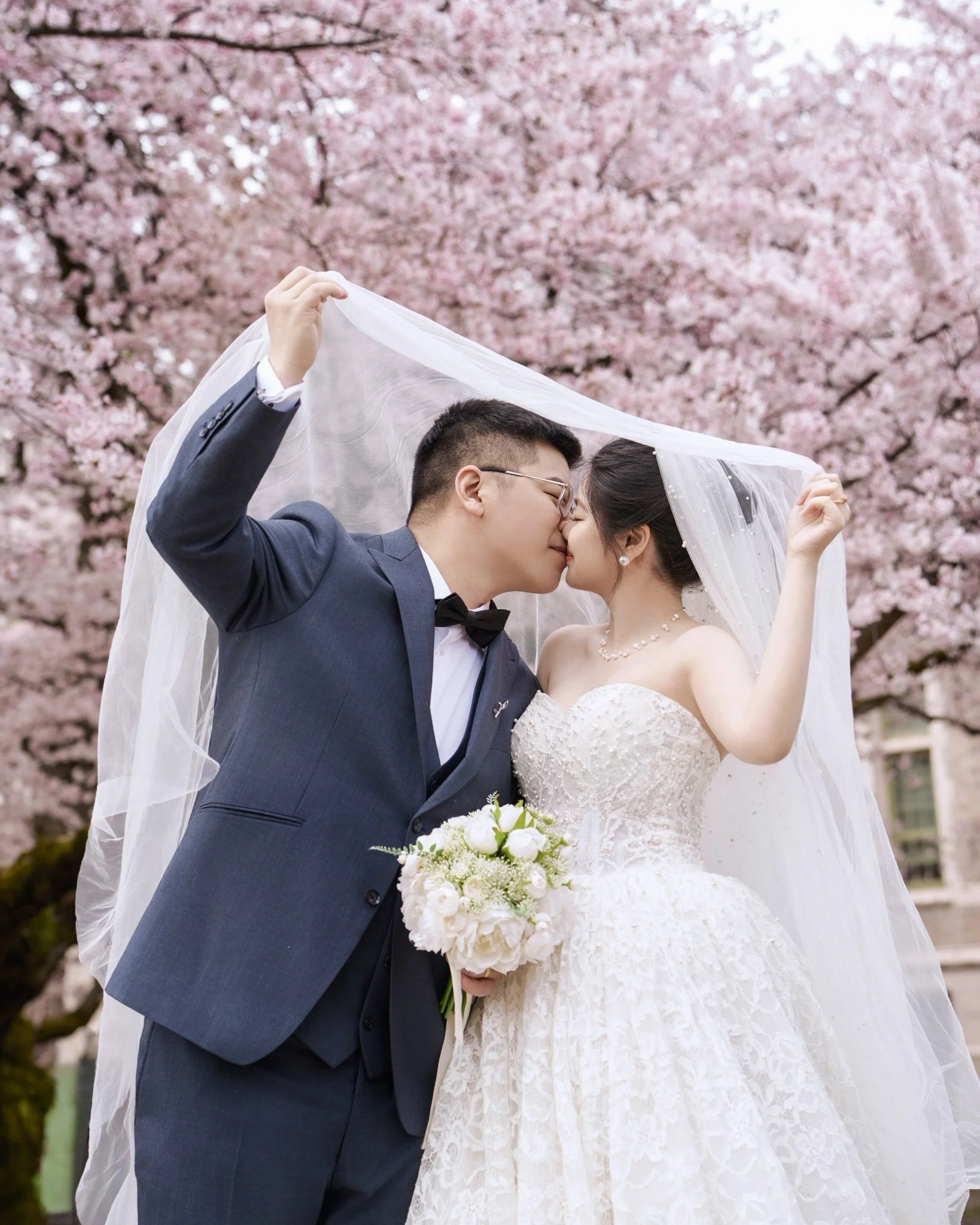 A promise made under something fleeting
and meant to last.

Spring unfolds In petals,
in the soft way her dress caught the wind
as if the season itself had softened for a love so young so radiant.

They bloomed.
So did the moment. 🌸
📍 University of