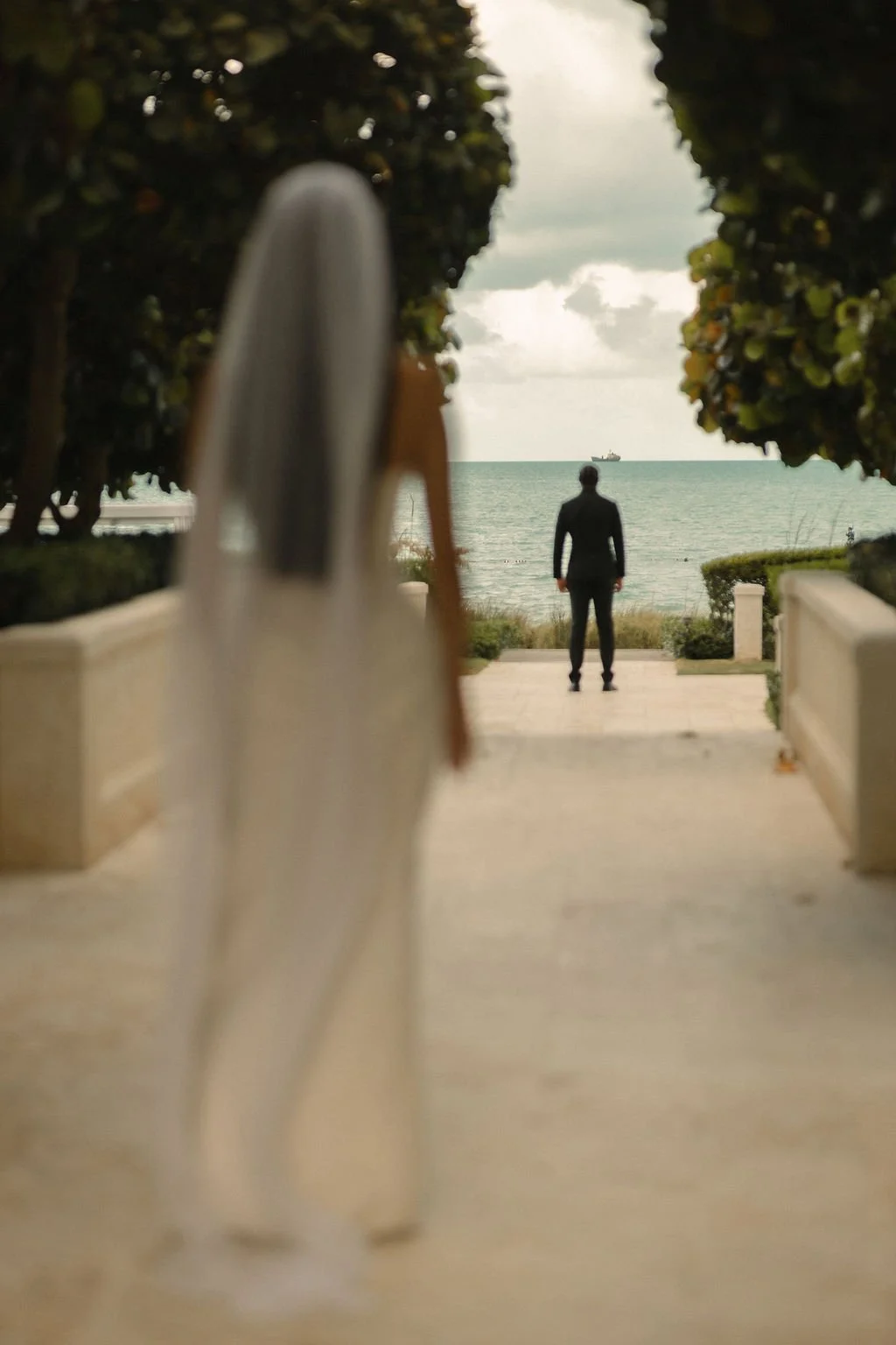 Natasha approaching Jacob for their first look overlooking the sea at The Shore Club.