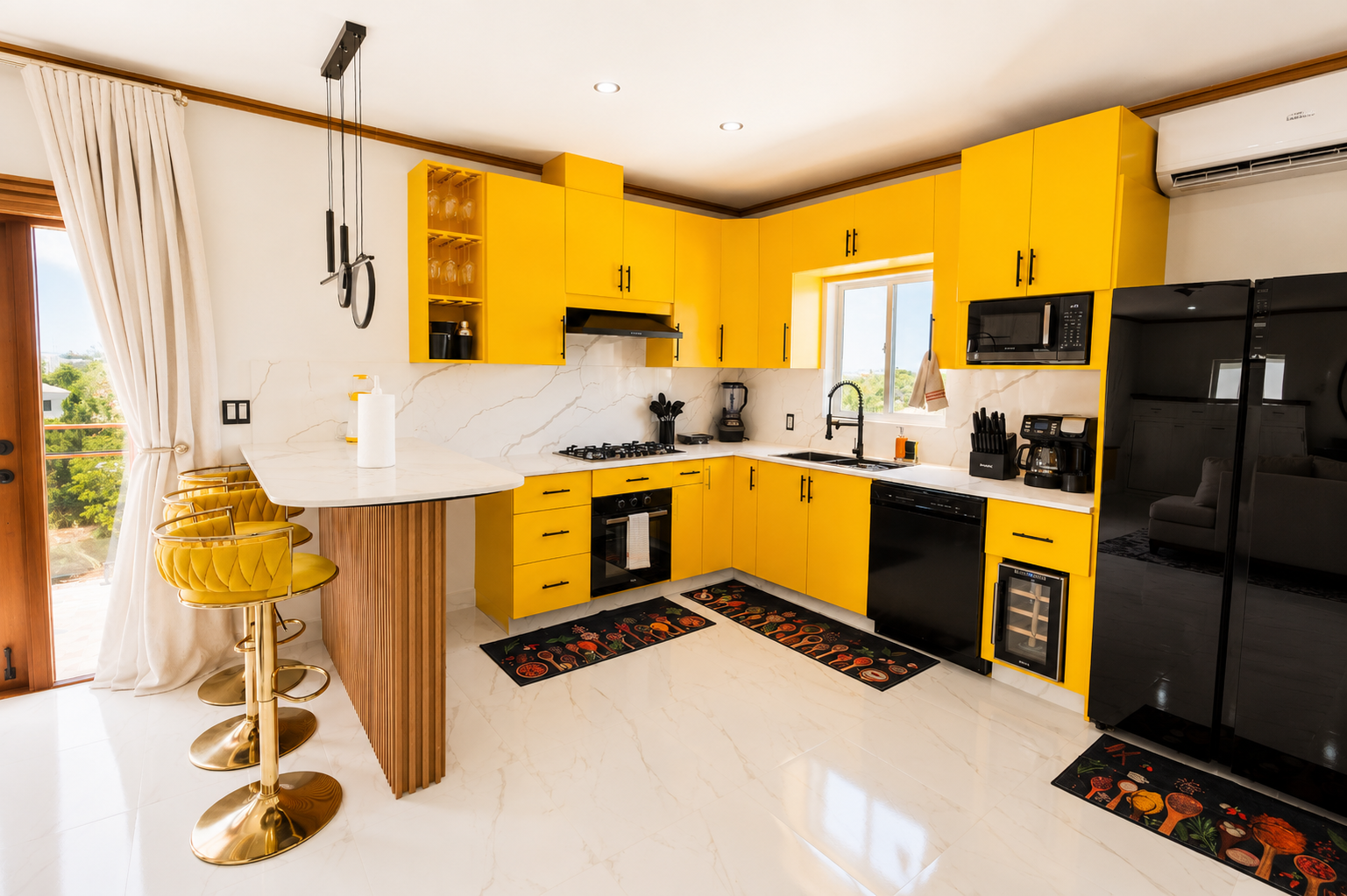 Bright yellow kitchen with black appliances, white marble countertops, and a breakfast bar with four yellow velvet barstools.