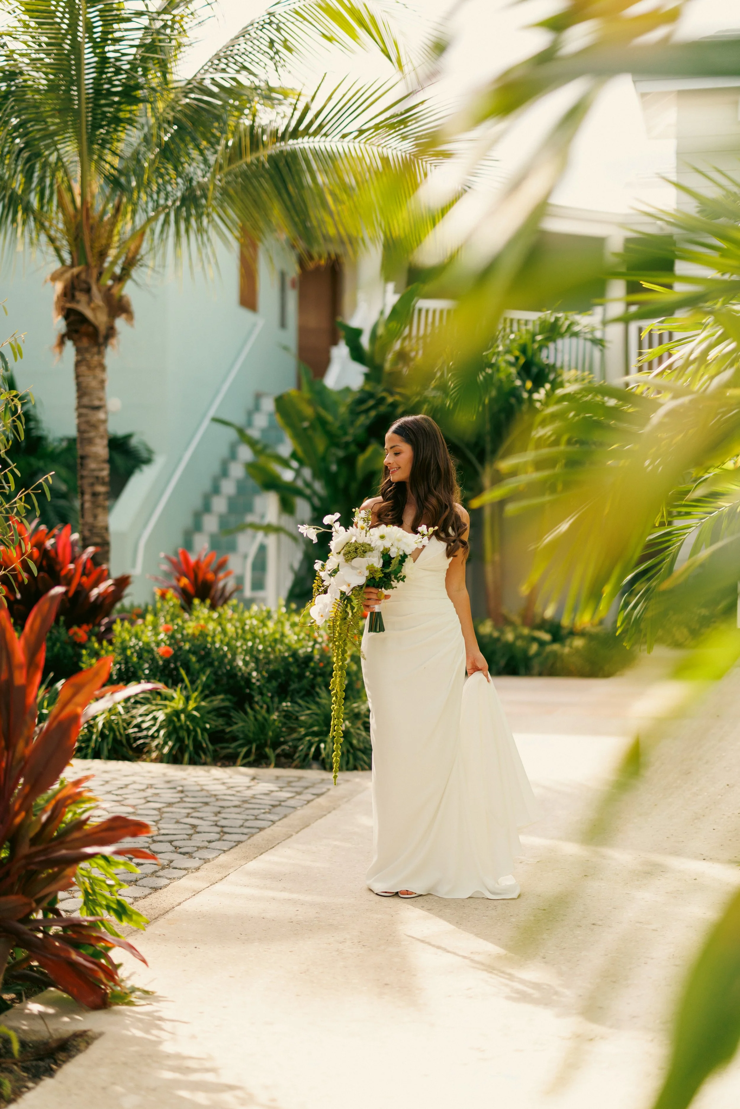 Brooke holding her white bouquet on a garden path at Beaches Turks and Caicos