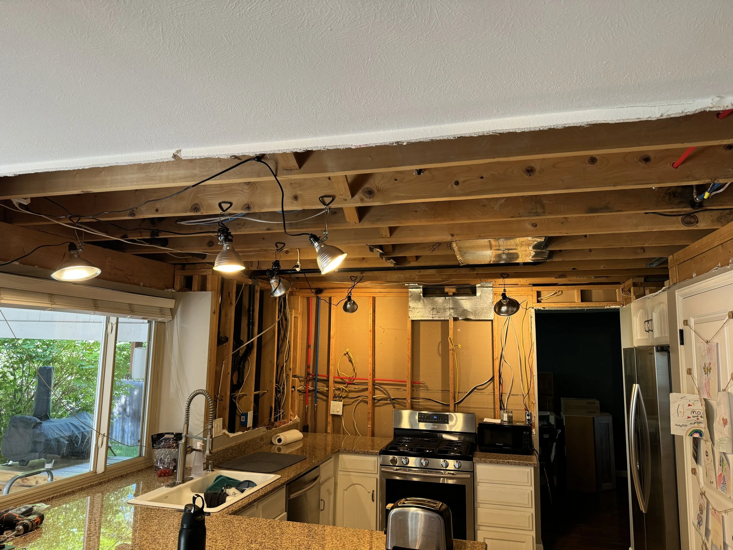 Current status: Plumbing (both drain/vent lines and hot and cold supply lines) has been moved and is in place, and the electrical has also been moved and is in place. The ceiling height is set--hooray, seven more inches of ceiling height, and full si