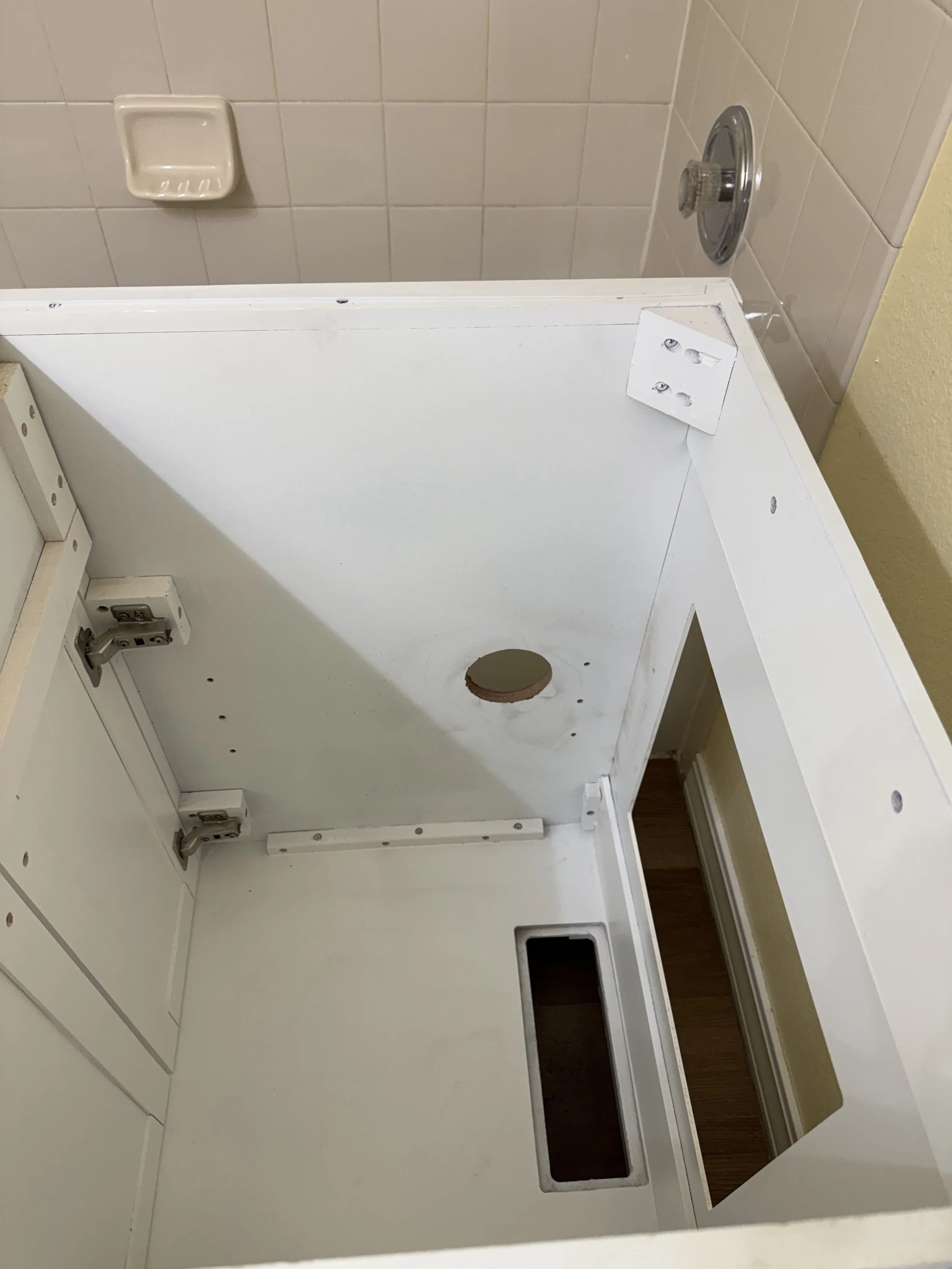 That's the surgery I had to do on the new vanity--measured the spot, used my hole saw, and voila!  The perfect location for the drain line.