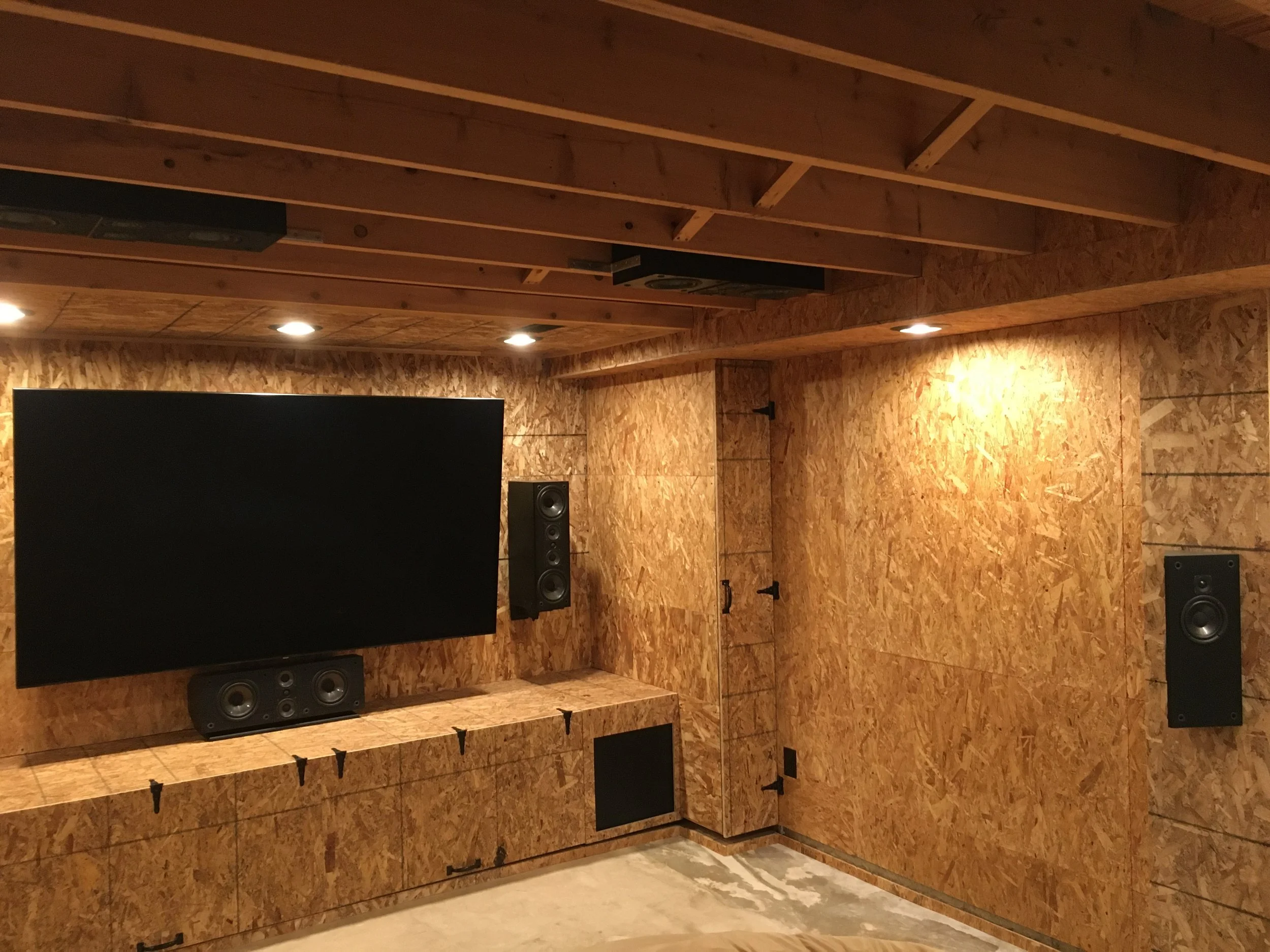 Sheathing is done, speakers re-connected, 85" QLED (on swing-out, articulating wall mount--since we still need access to the egress window) is installed.