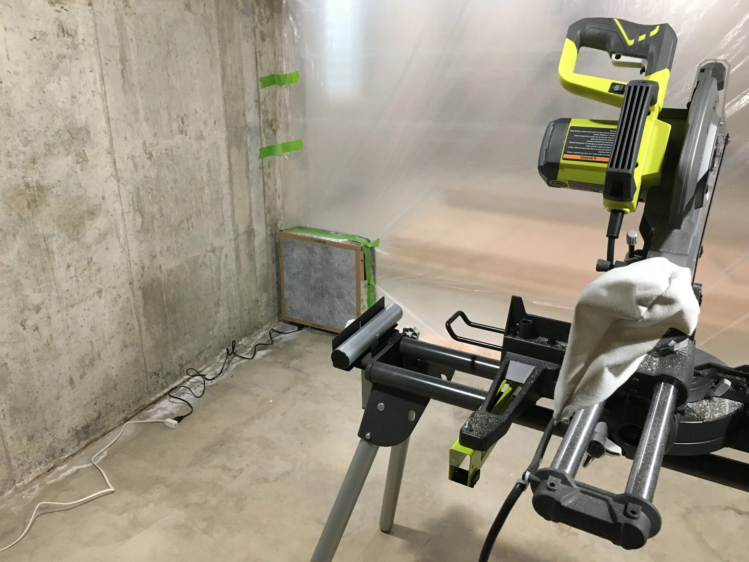 Plastic tarp and box fan filter--worked great to minimize the dust.