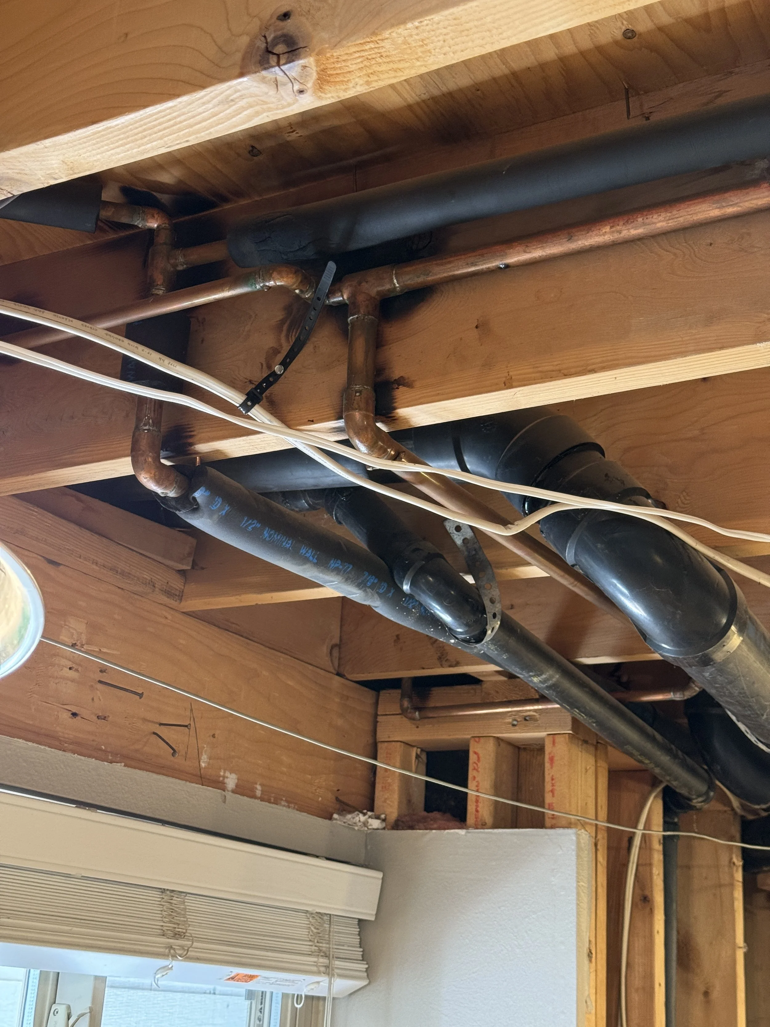 First, the water supply lines. I simply converted the supply lines below the joists to PEX, moved them up, then connected them back to the existing copper using Shark Bite connections.