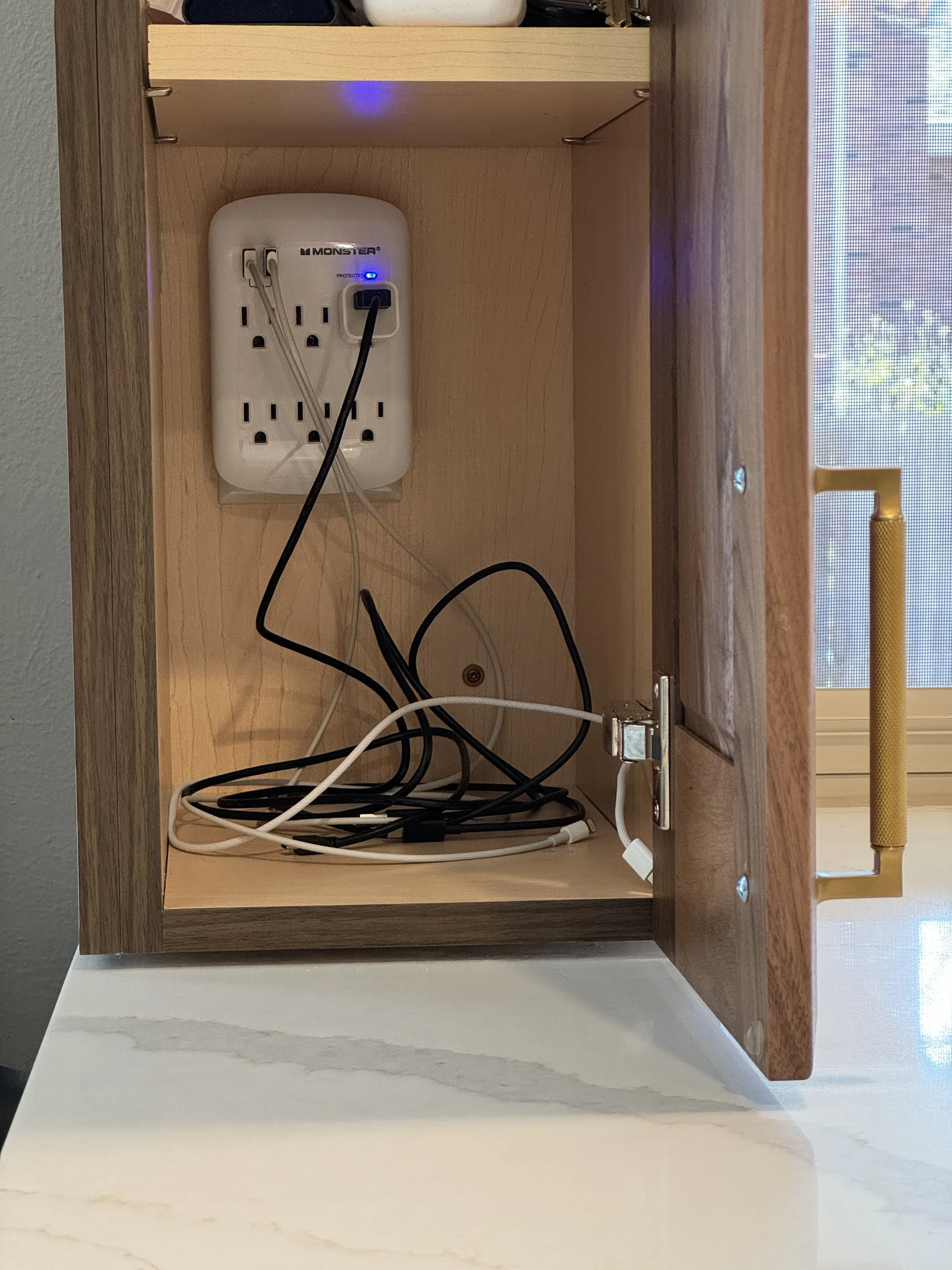 No more phones charging on the countertop!  They're tucked neatly away in this cabinet.  This is very helpful for my OCD!  lol