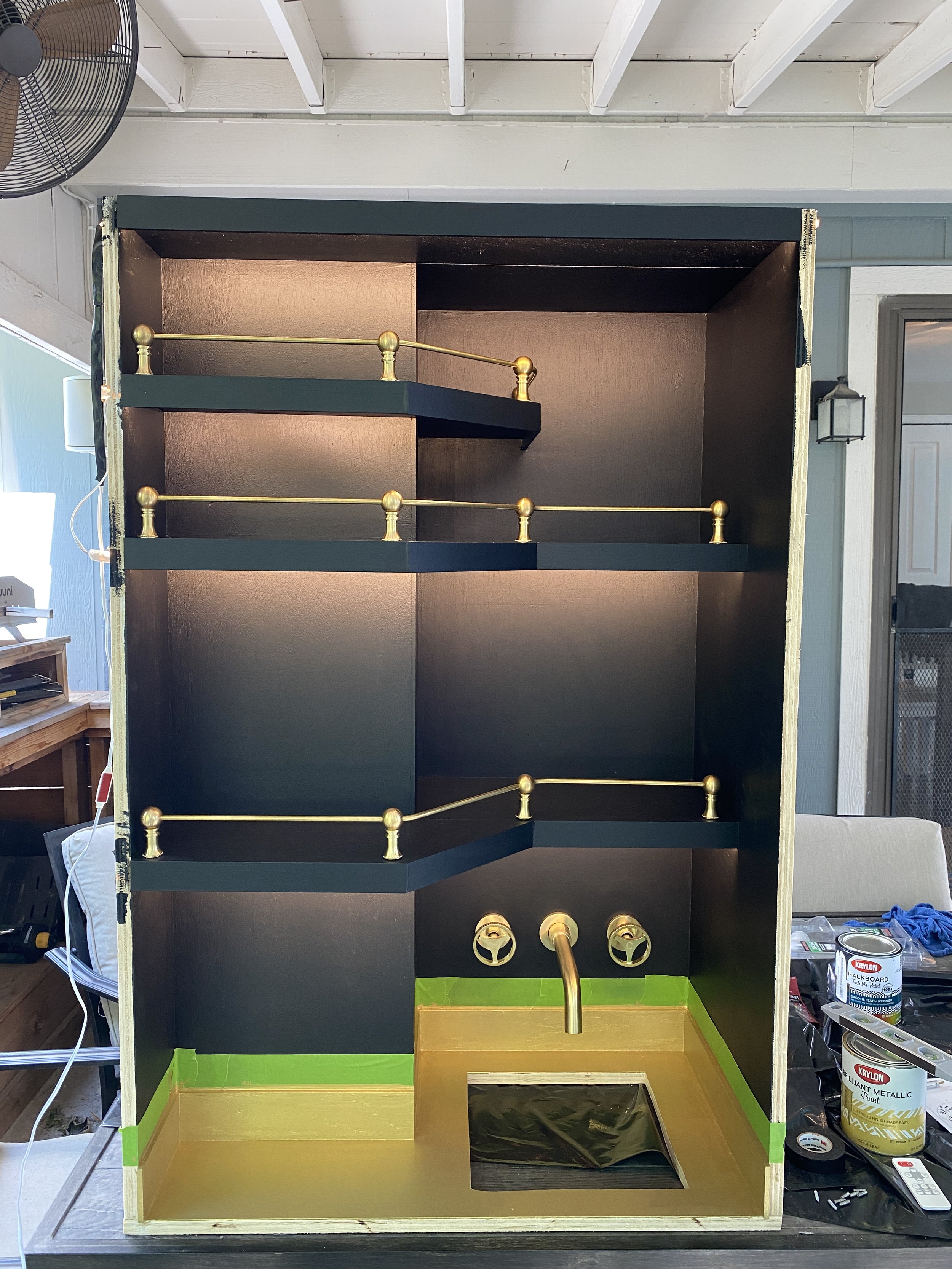 Added LED lighting strips, a faucet, and some fancy-pants brass bar rails I found online.