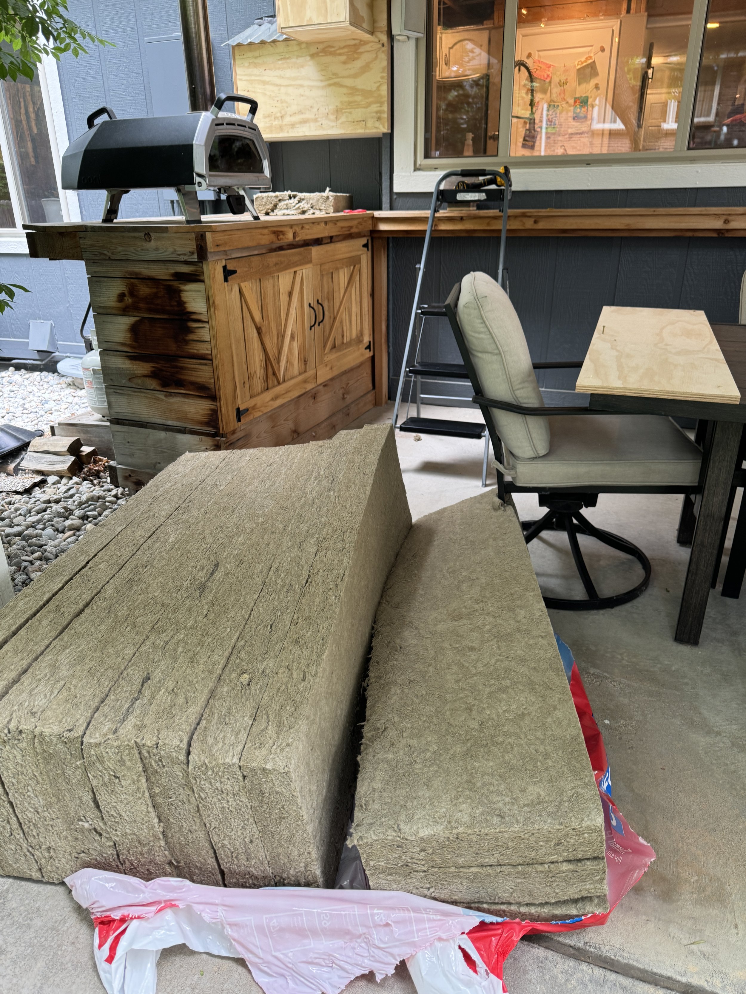 Next, I needed to insulate the exterior walls.  I went with Rockwool insulation (like I did in the basement), because it has a higher R-value, doesn't absorb water (so no mold or mildew), and is incredibly fire-resistant and can act as a fire-stop.  