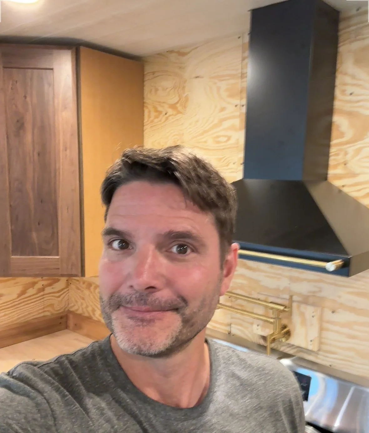 Corner wall cabinet is in--selfie with it and the range hood!  lol