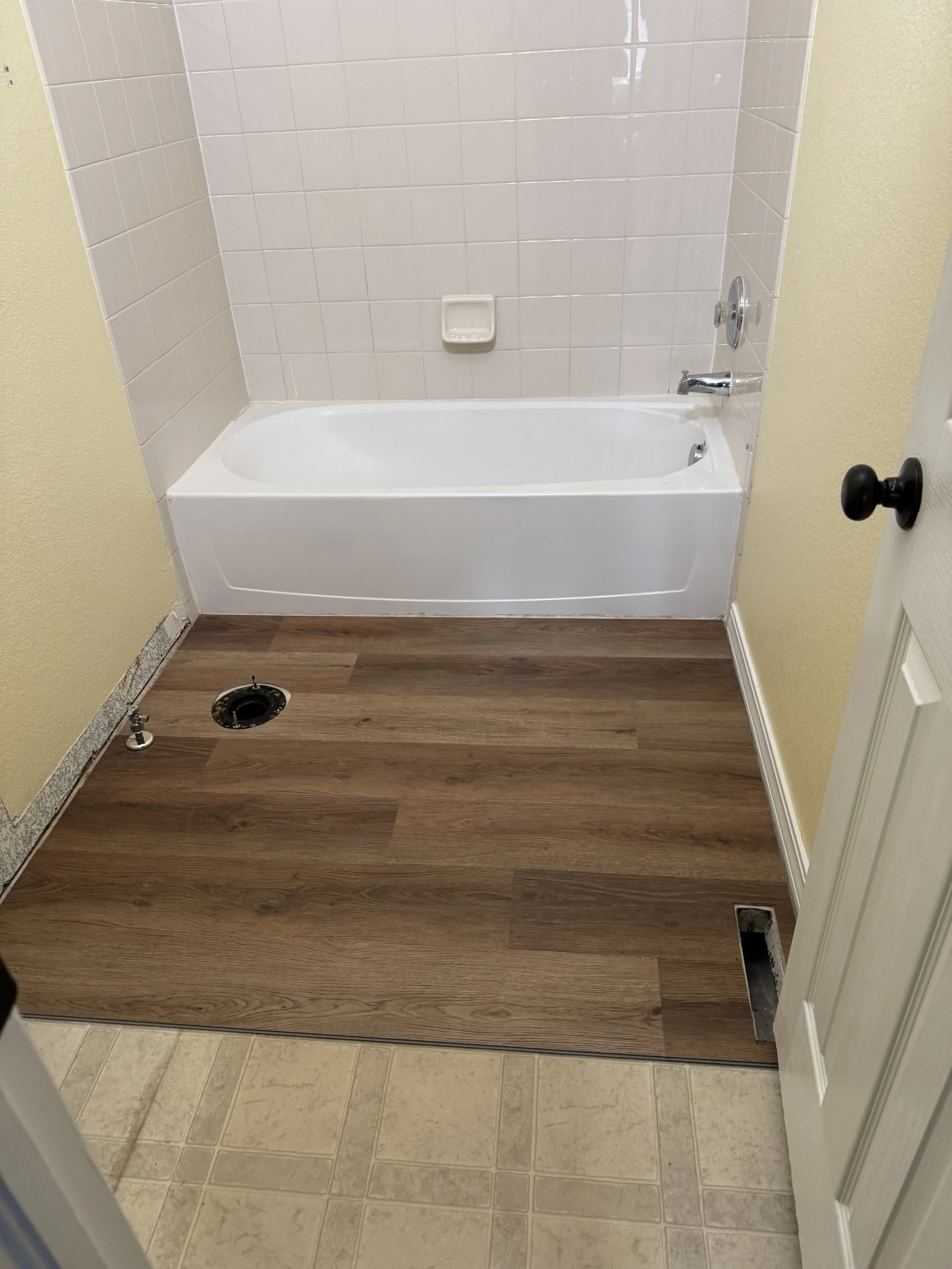 Luxury Vinyl Plank (LVP)--such a great product!  Waterproof, durable, and beautiful.  And it can be installed directly over any old flooring, which saves a ton on labor costs. :)