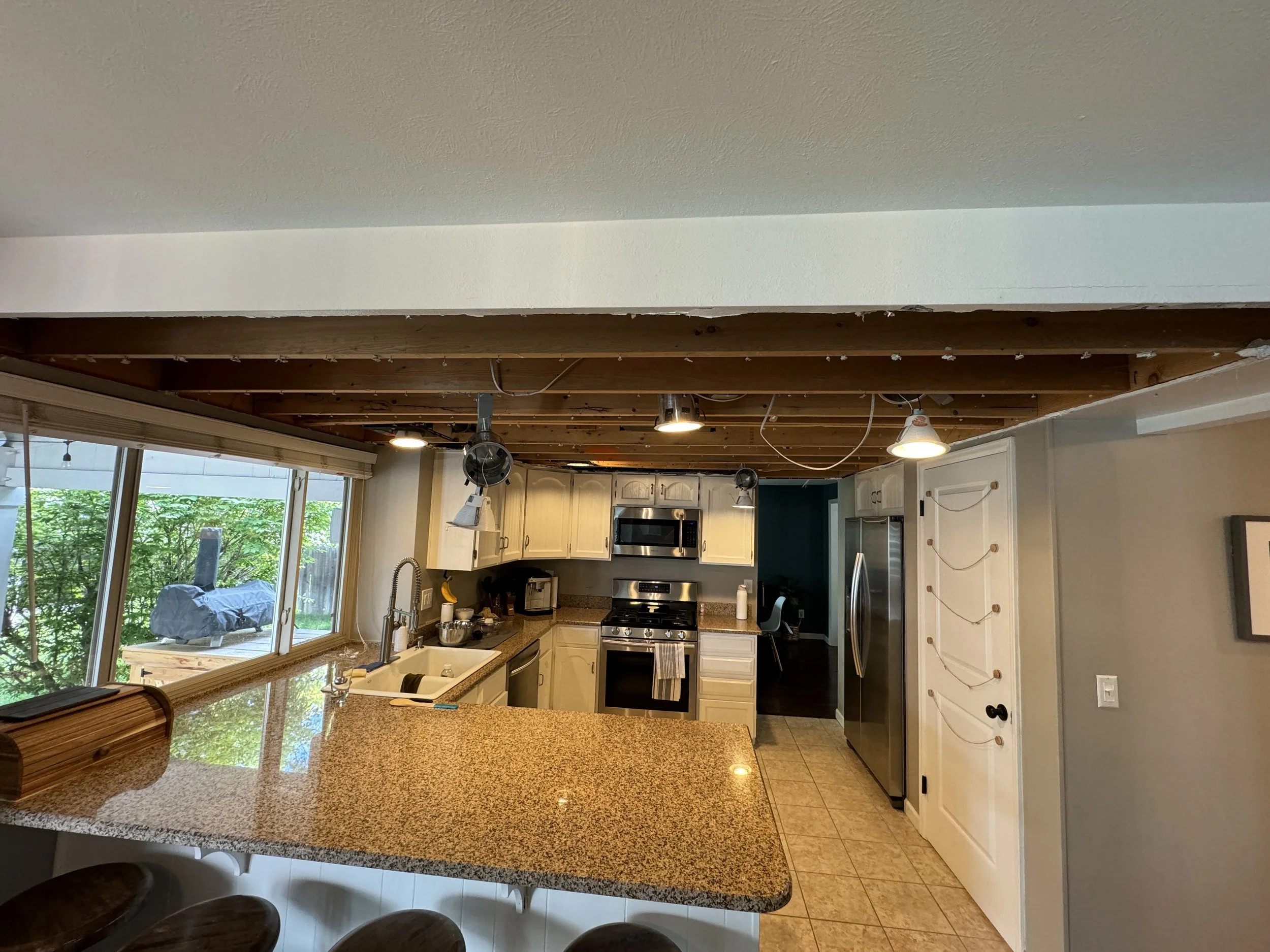 Now the drywall on the ceiling is gone, and I can see that--since they had a drop ceiling--they just ran the electrical wiring all willy-nilly. Fun!