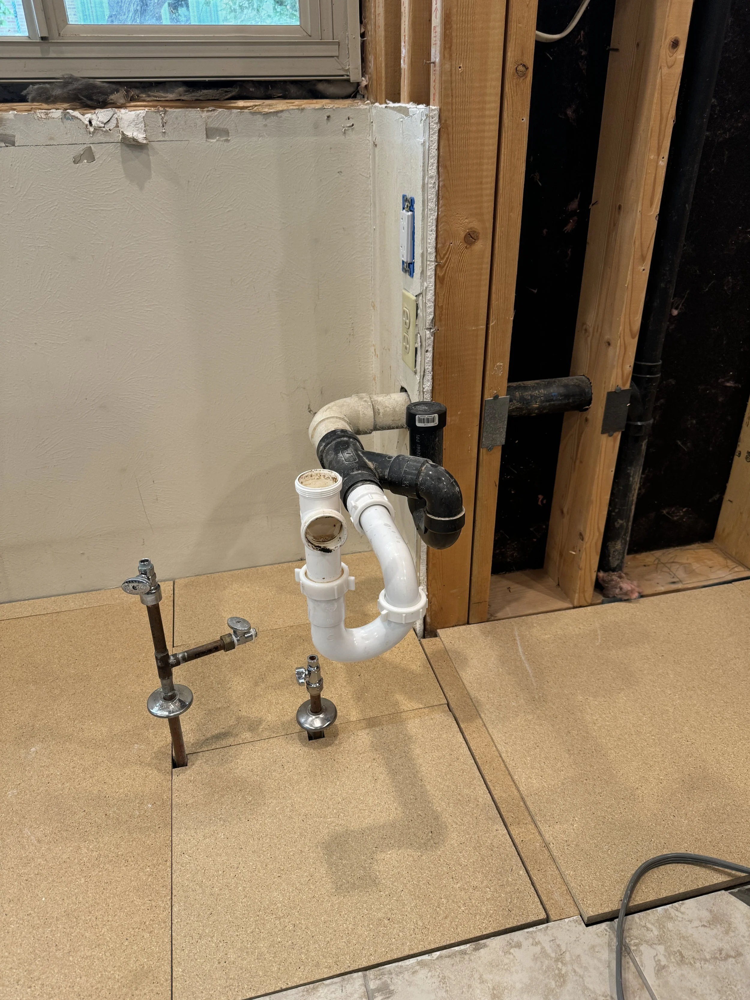 I had to clean this up, re-route the water supply lines, and reconfigure the drain lines... There is no way to slide the new sink base cabinet to the wall, the way this is here.