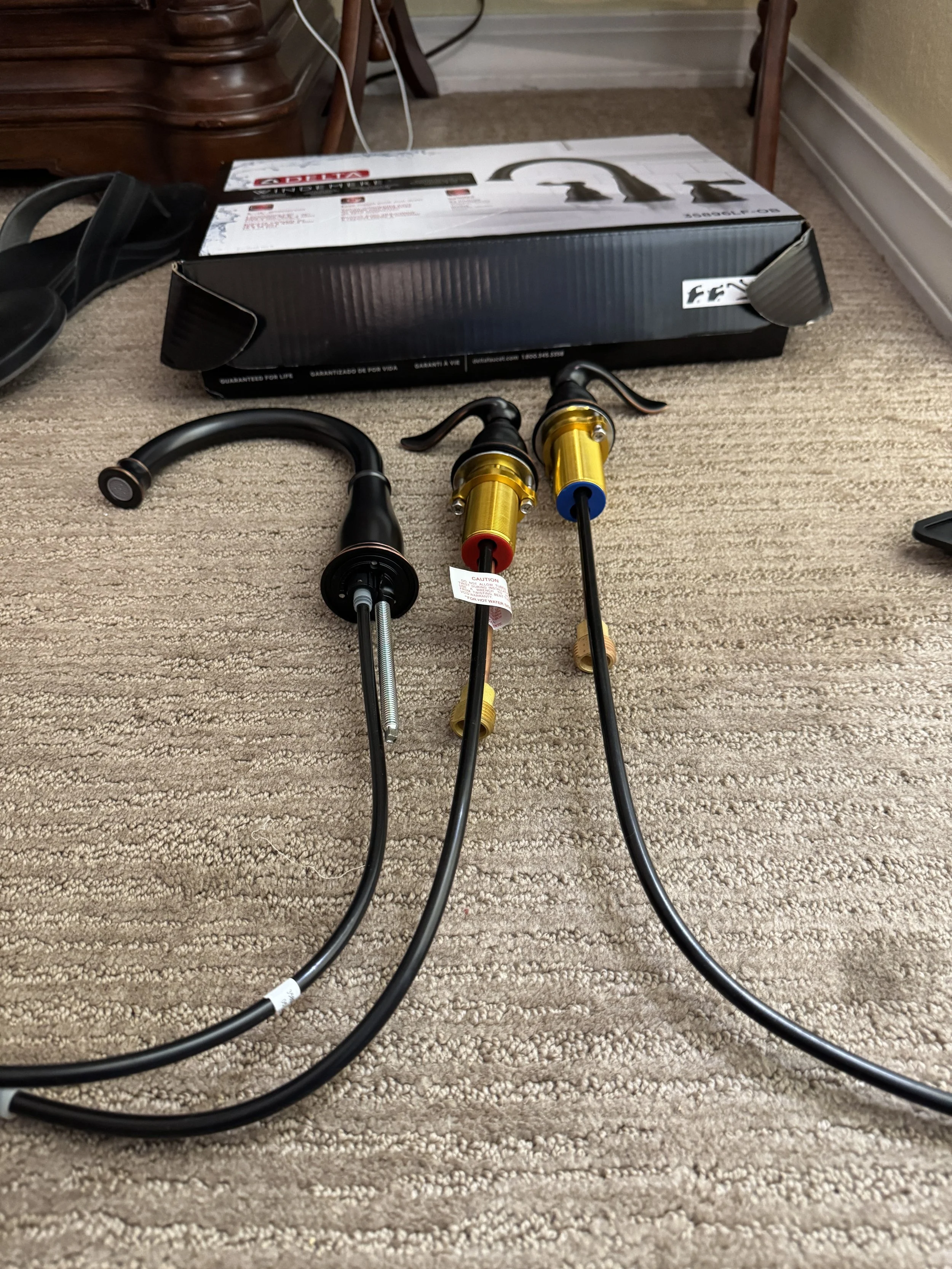 Connecting the new bronze hardware to the marble topped vanity...