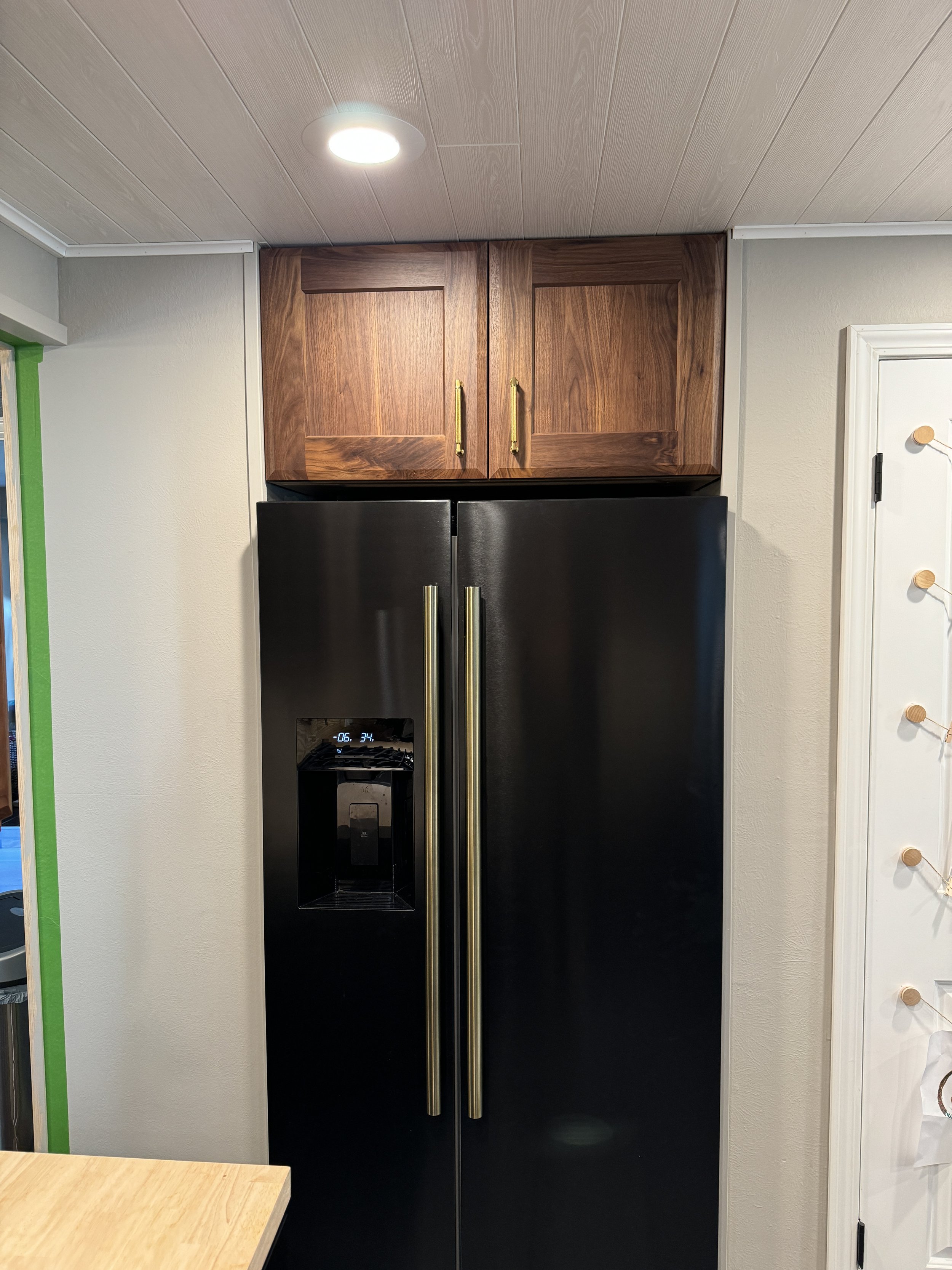 New black stainless steel side-by-side fridge  (painter's tape to the right shows that I'm still doing some touching up.)