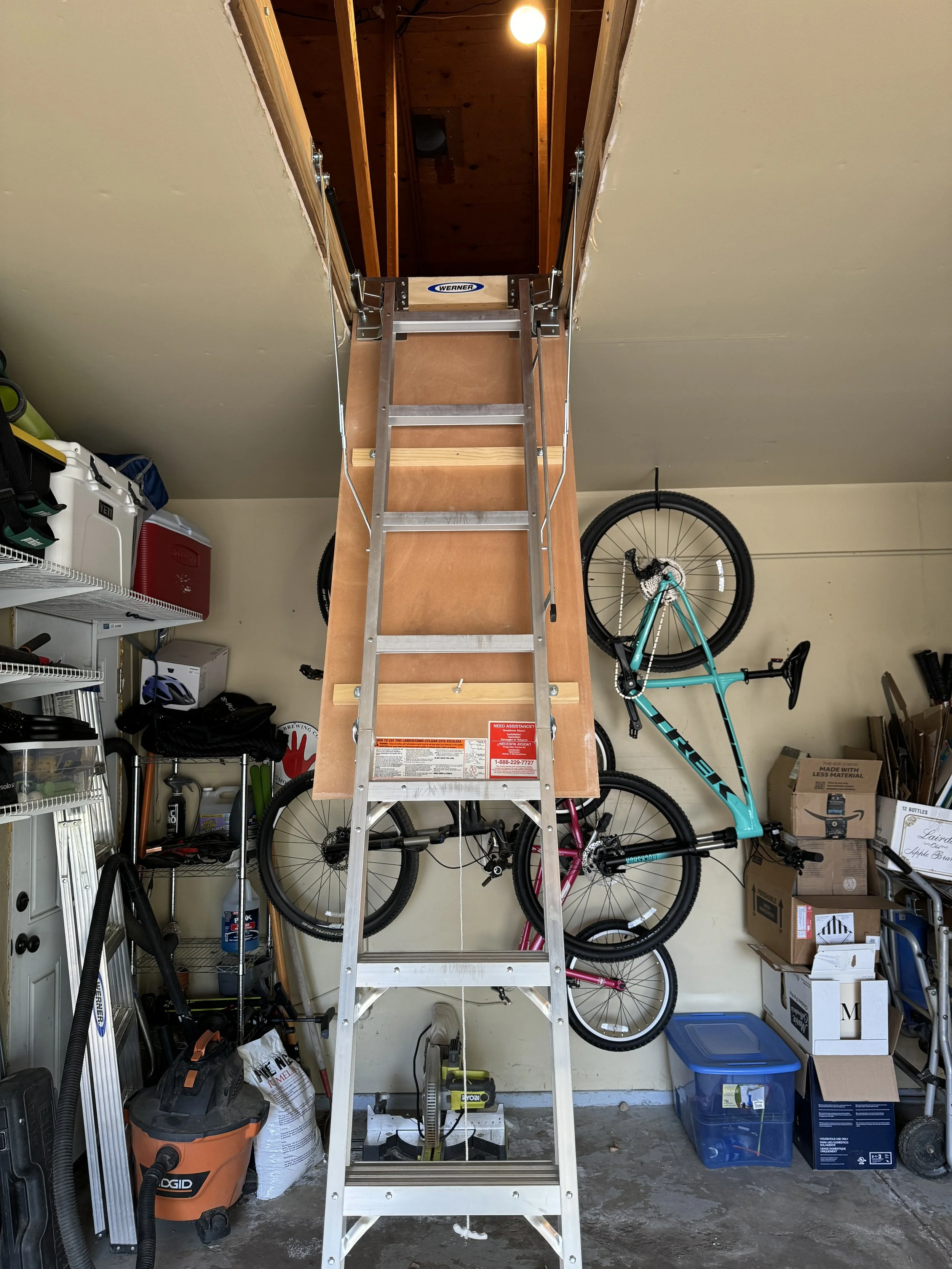 Install the attic stairs, and add the lighting--nothing too fancy, just a bunch of clip lights, but it made it nice and bright!