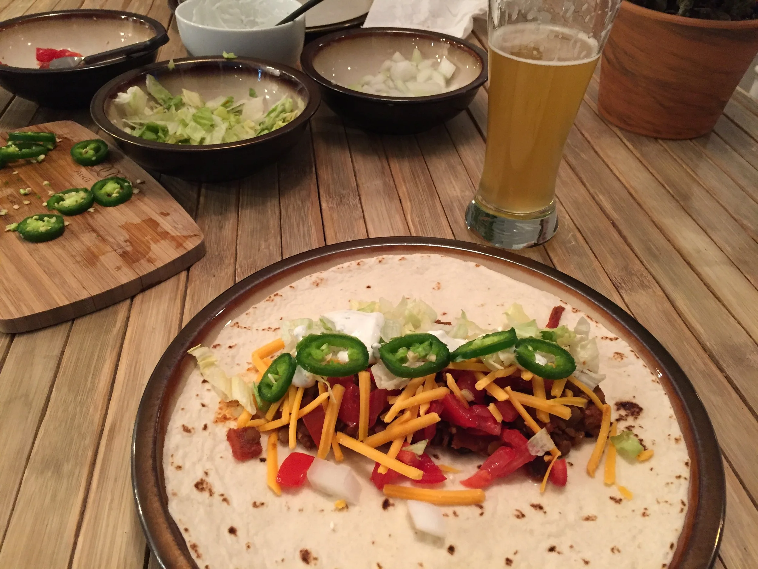 Vegetarian chili burrito, with fresh jalapenos, tomatoes, onions, shredded cheddar... and washed down with an ice cold beer.  Perfection!