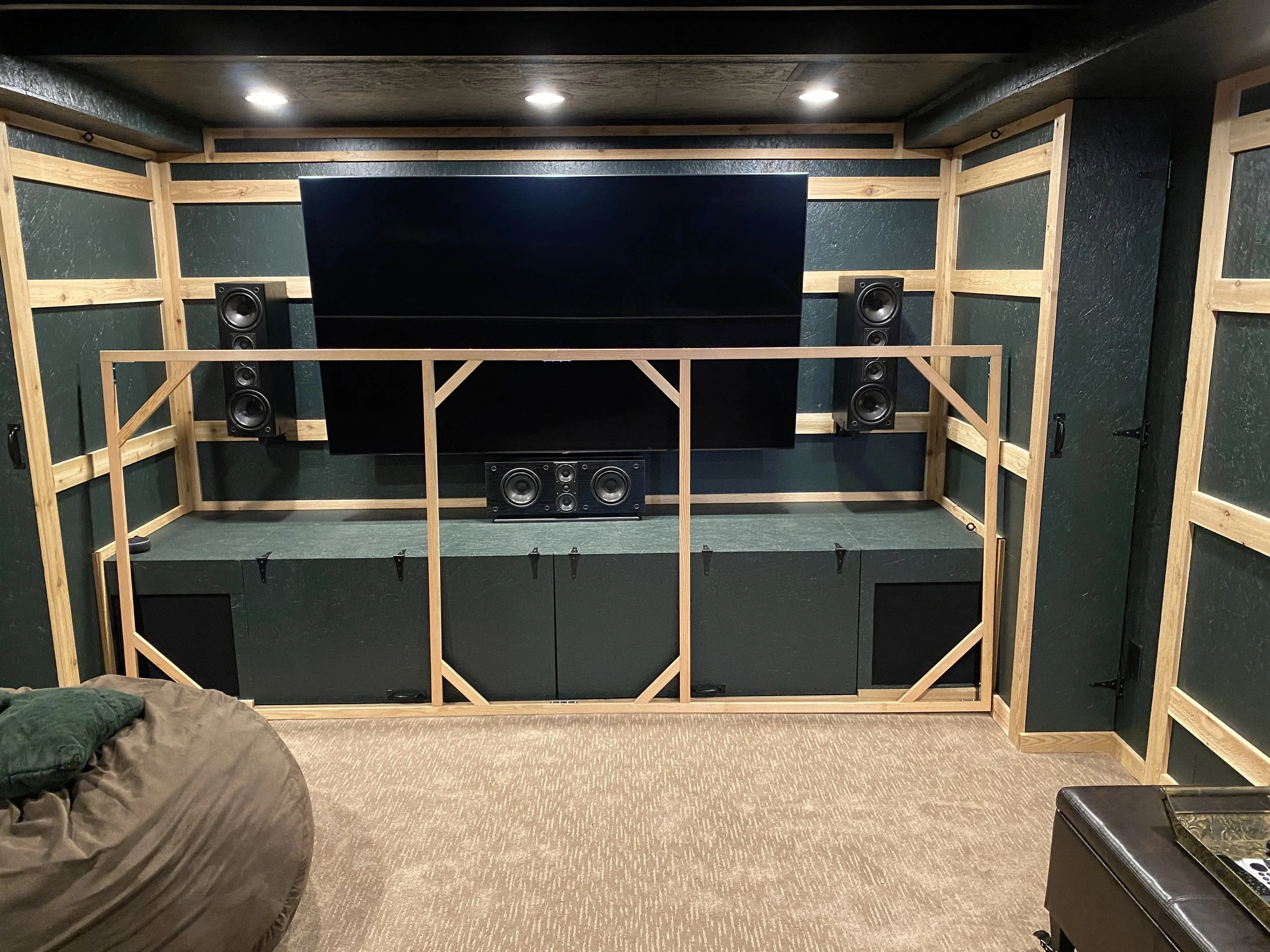 A fun update to the basement playroom/media room: I built a 138" diagonal spandex screen (Jamie helped, too) ! It works perfectly, and the sound from the speakers goes right through it. 