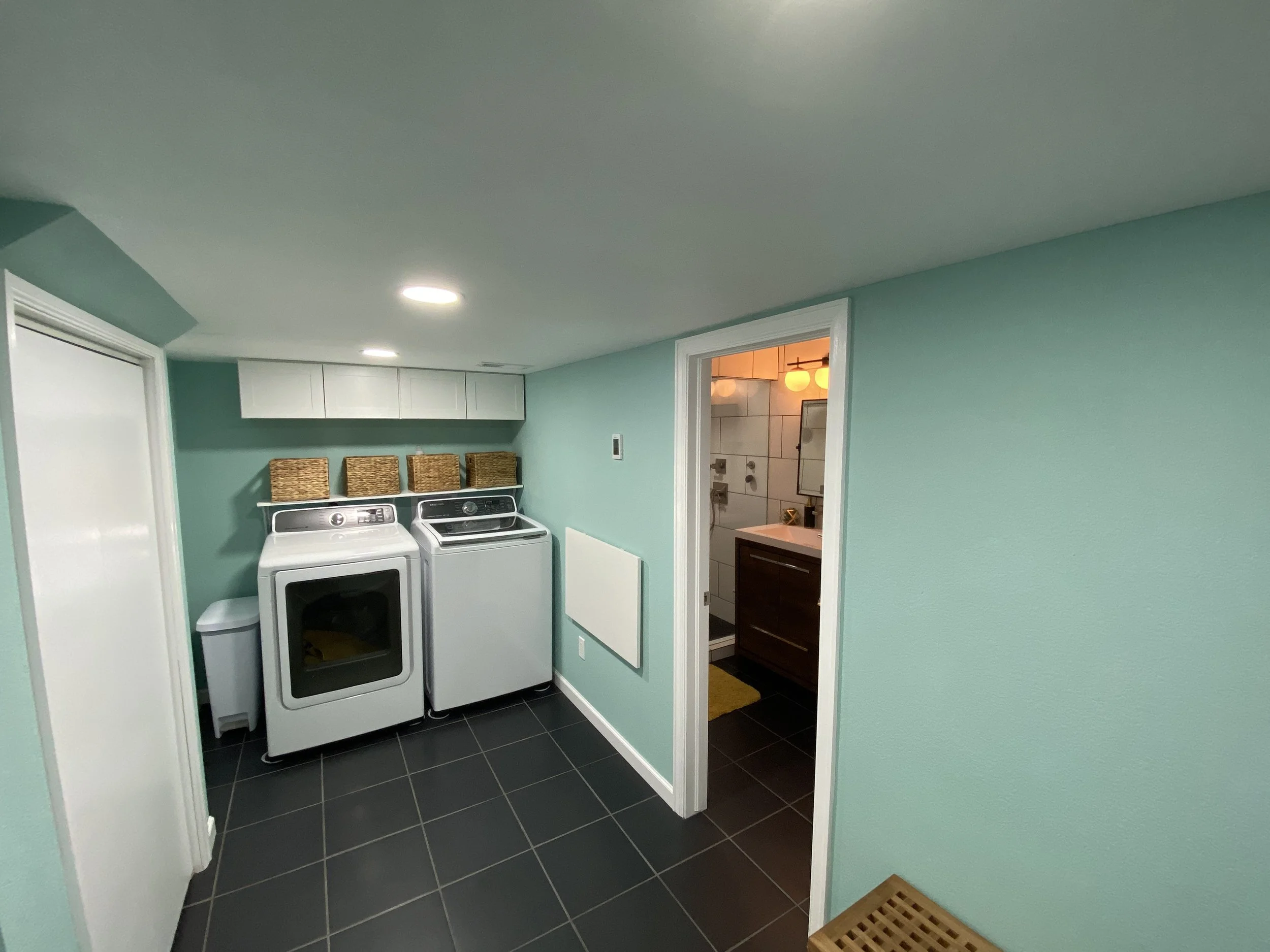 Washer and dryer are in, storage has been added above, and the doorway to the steam shower bathroom is open.  The was a great addition to our home!  :)