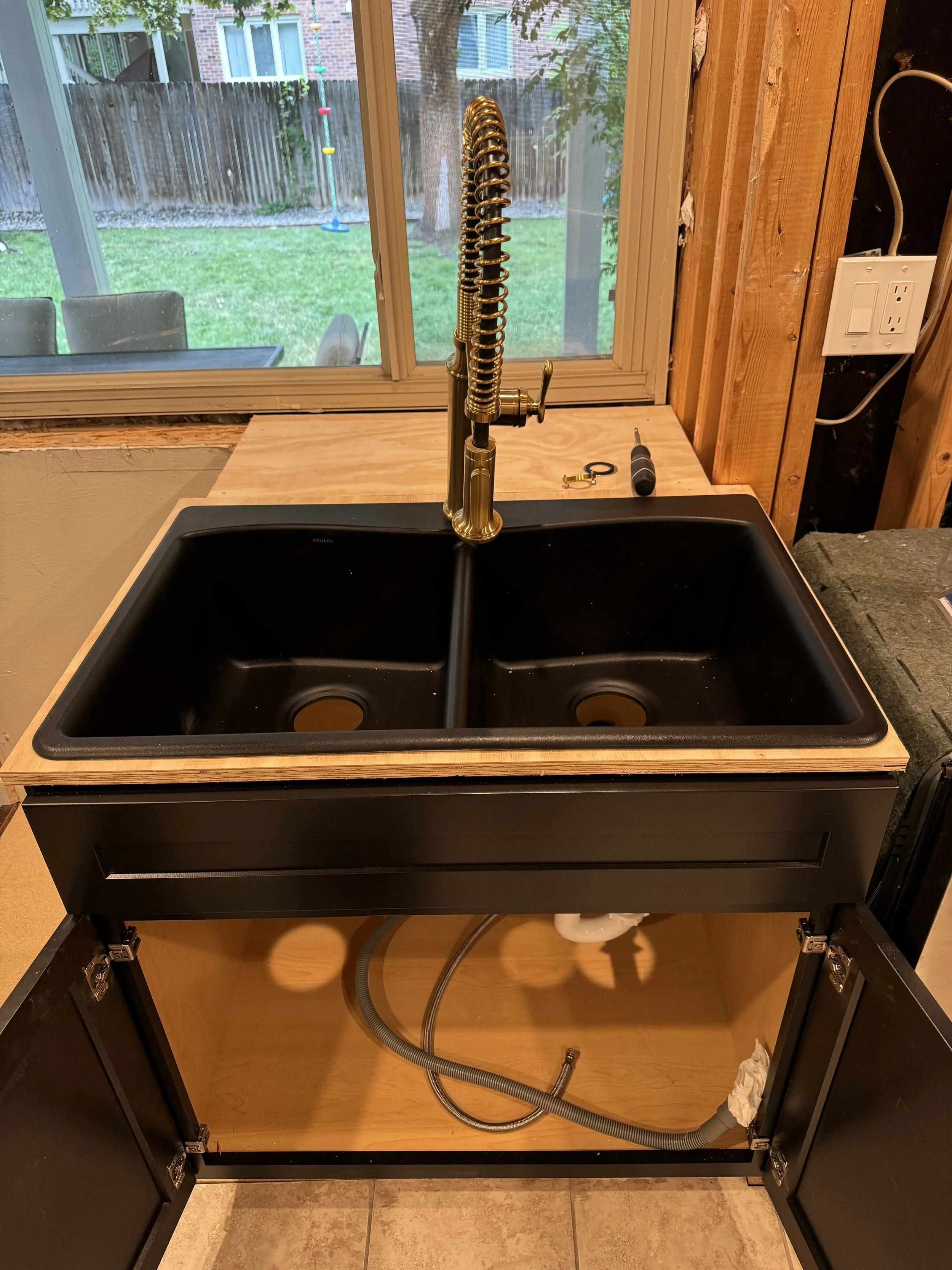 And now I can install the new sink base, sink, faucet, and disposal.  Good to have a sink again!