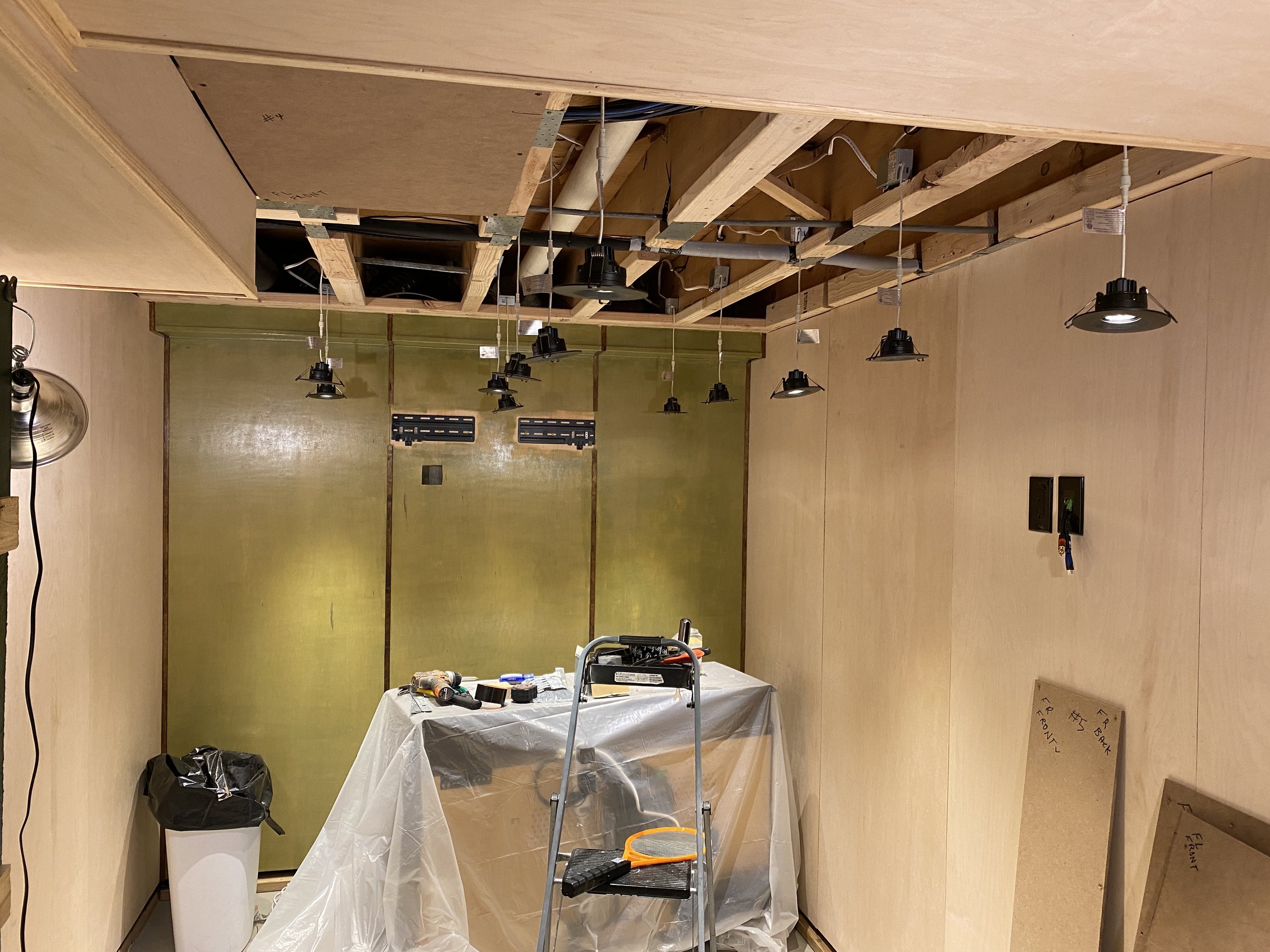 Staining the walls a perfect avocado green (I mean, it's a 70's lounge), getting the recessed lighting installed, and prepping the ceiling to install the panels.