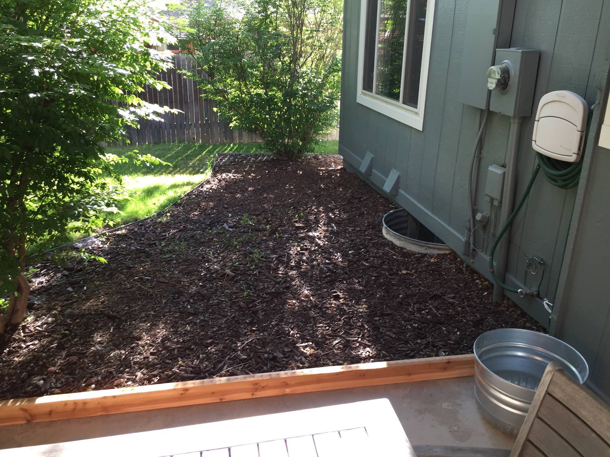 This space needed some help… I started with a cedar 2x4 spanning the patio--which will have the added benefit of stopping the mulch from blowing across on windy days.