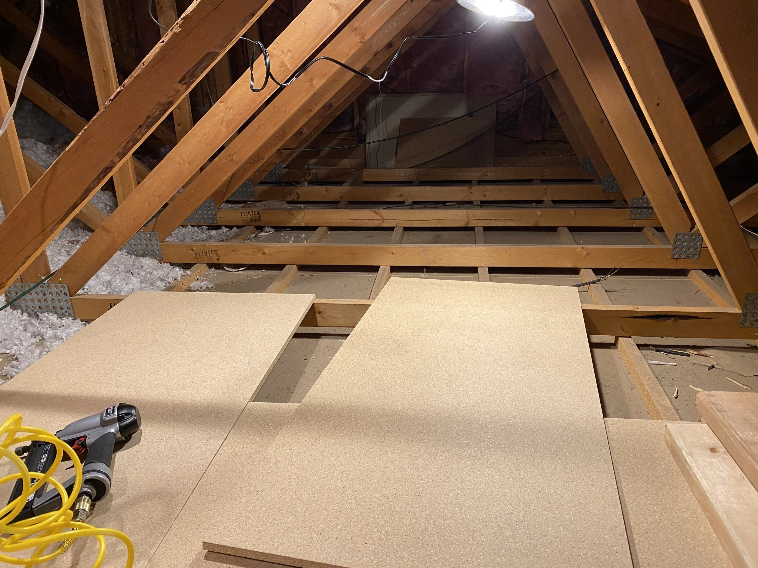Adding the flooring over the trusses.  Carrying those 2' x 4' sheets up the stairs was a bit challenging, I have to say...