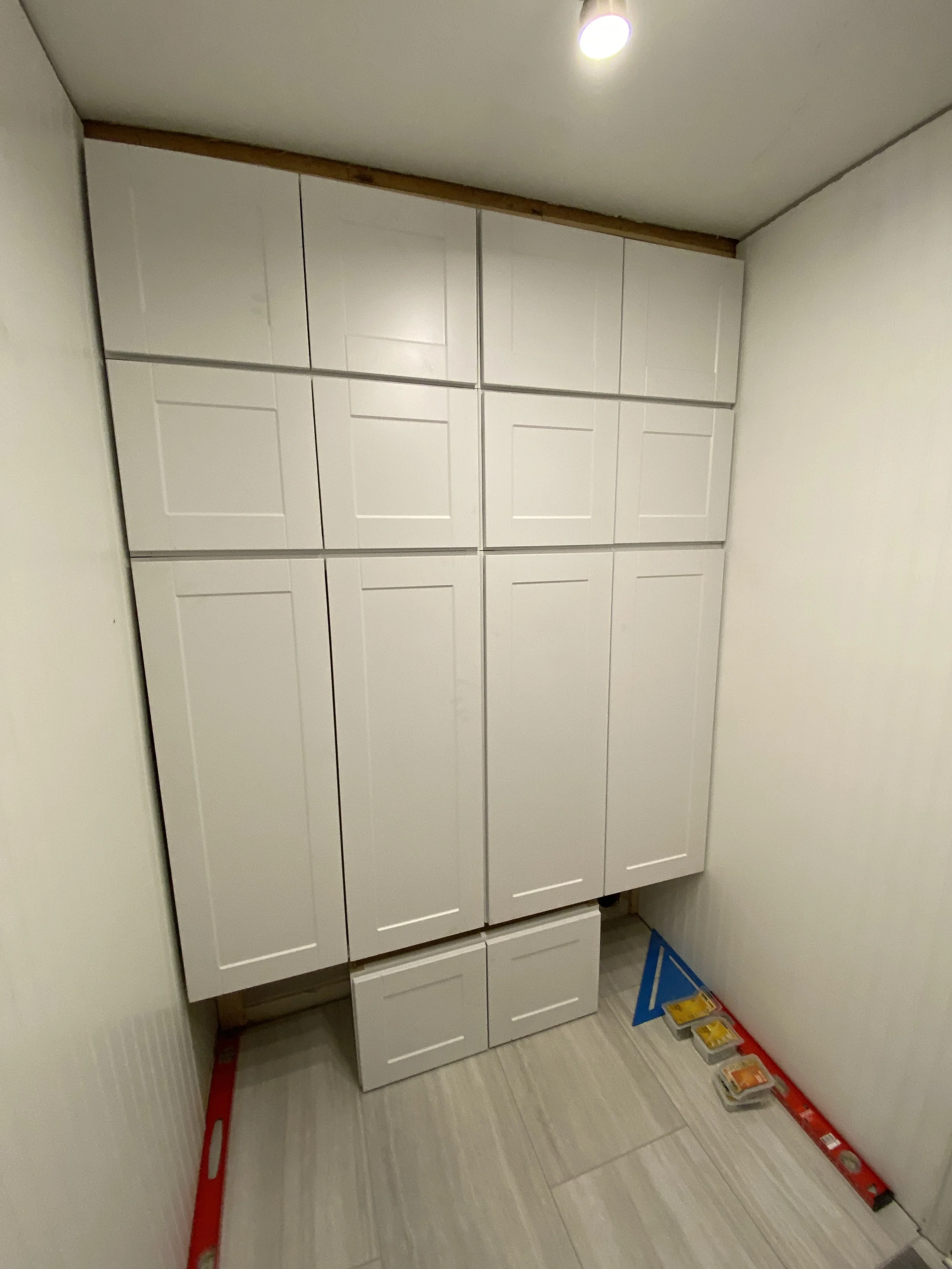 Got all the cabinets up, then decided to build my own cubbies underneath. The bench would go on top of those cubbies.