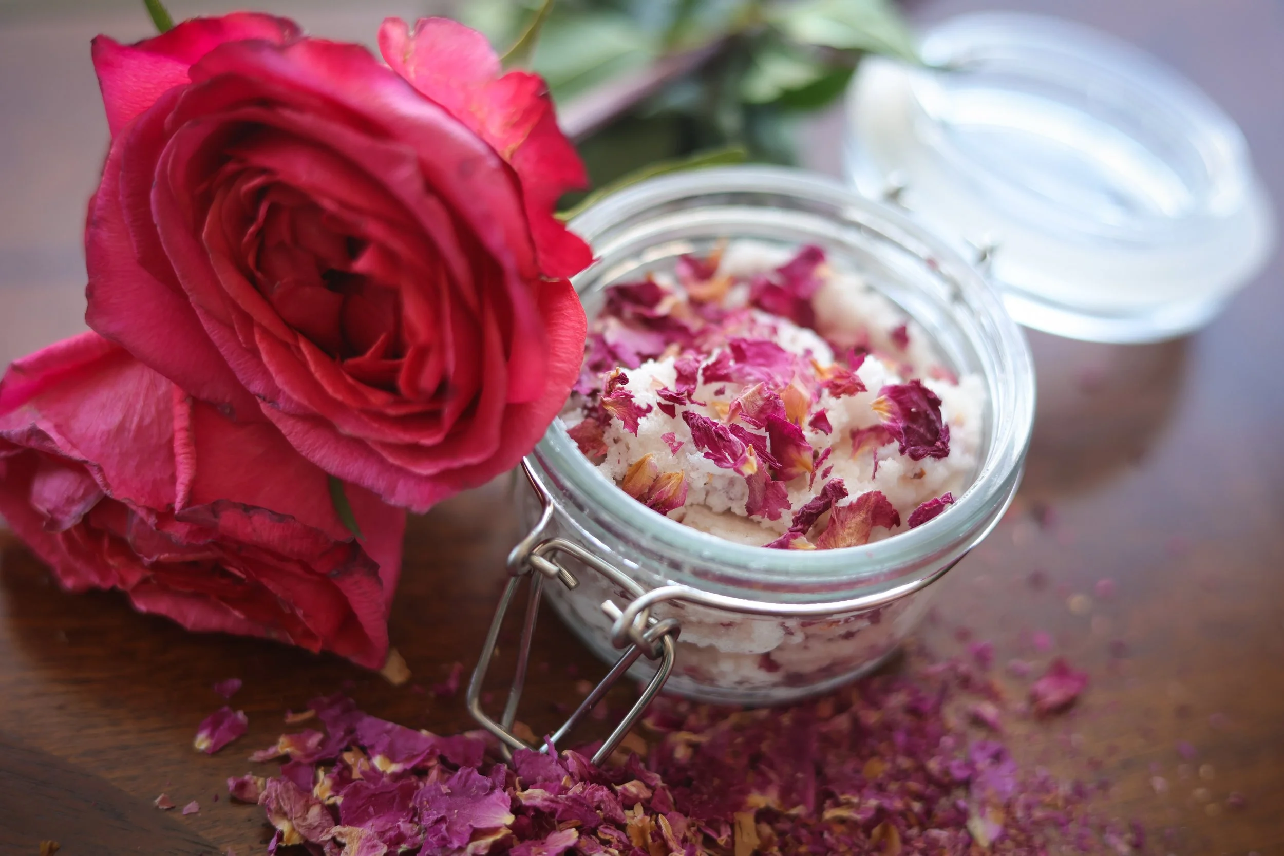 image of roses, rose petals and self made sugar scrub in a jar