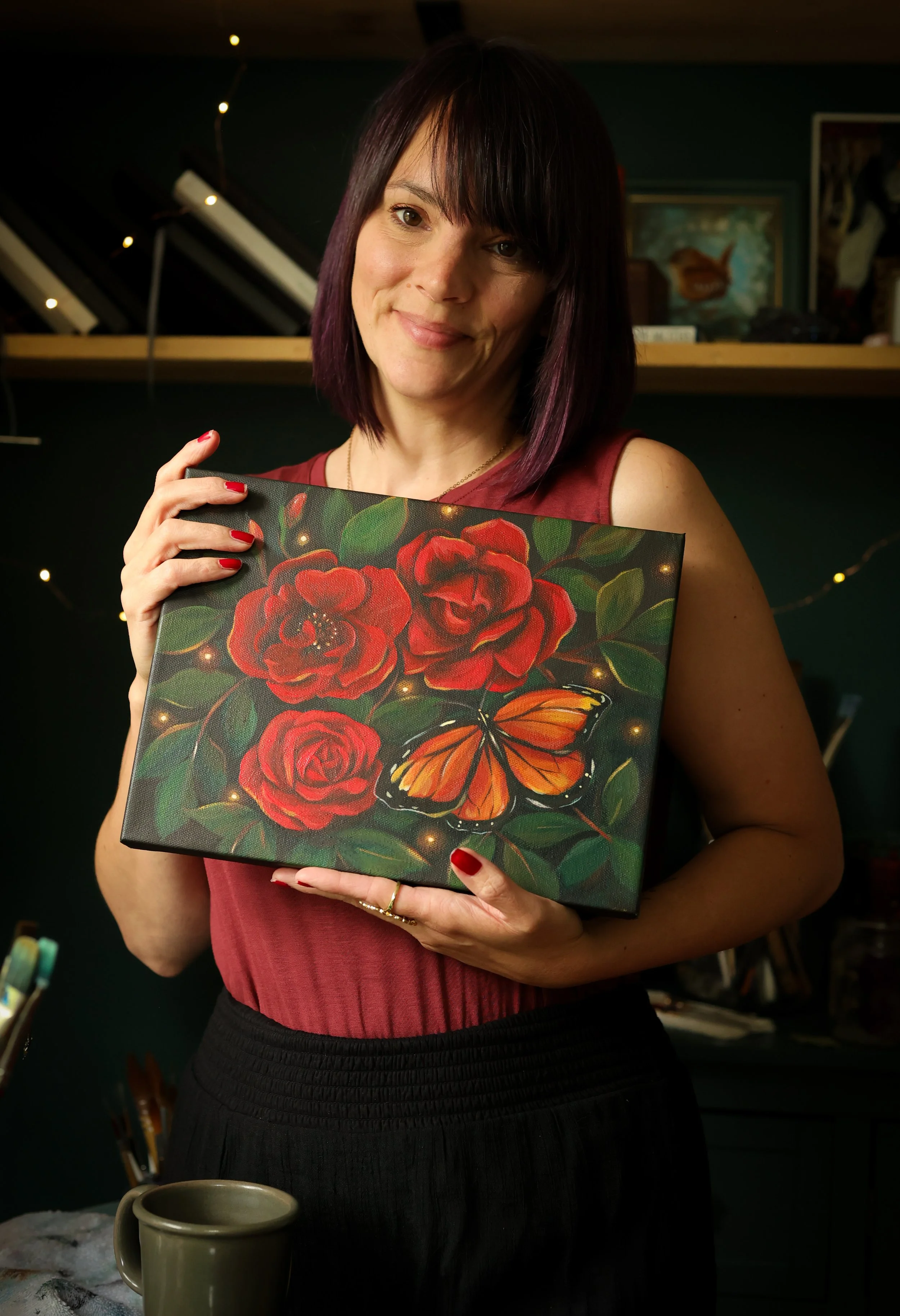 artist with roses and monarch painting