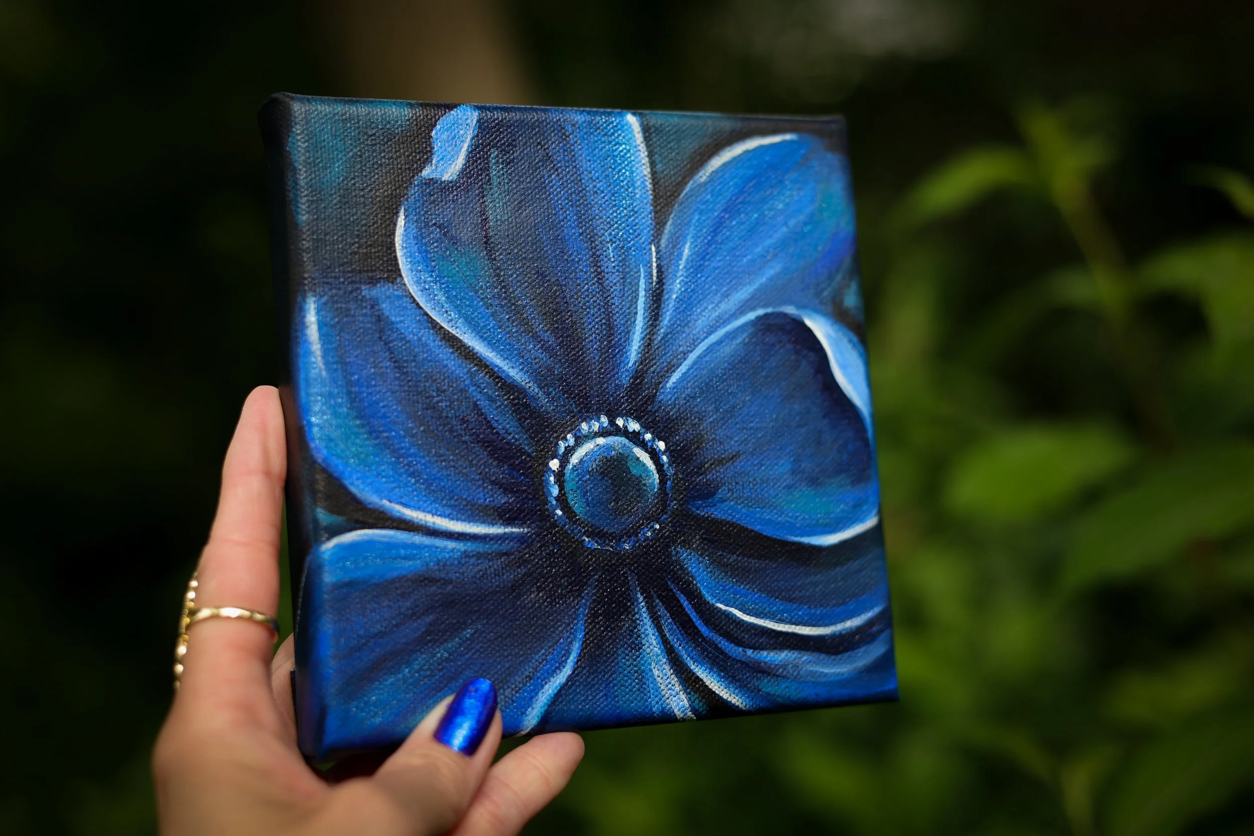 a painting of a blue flower