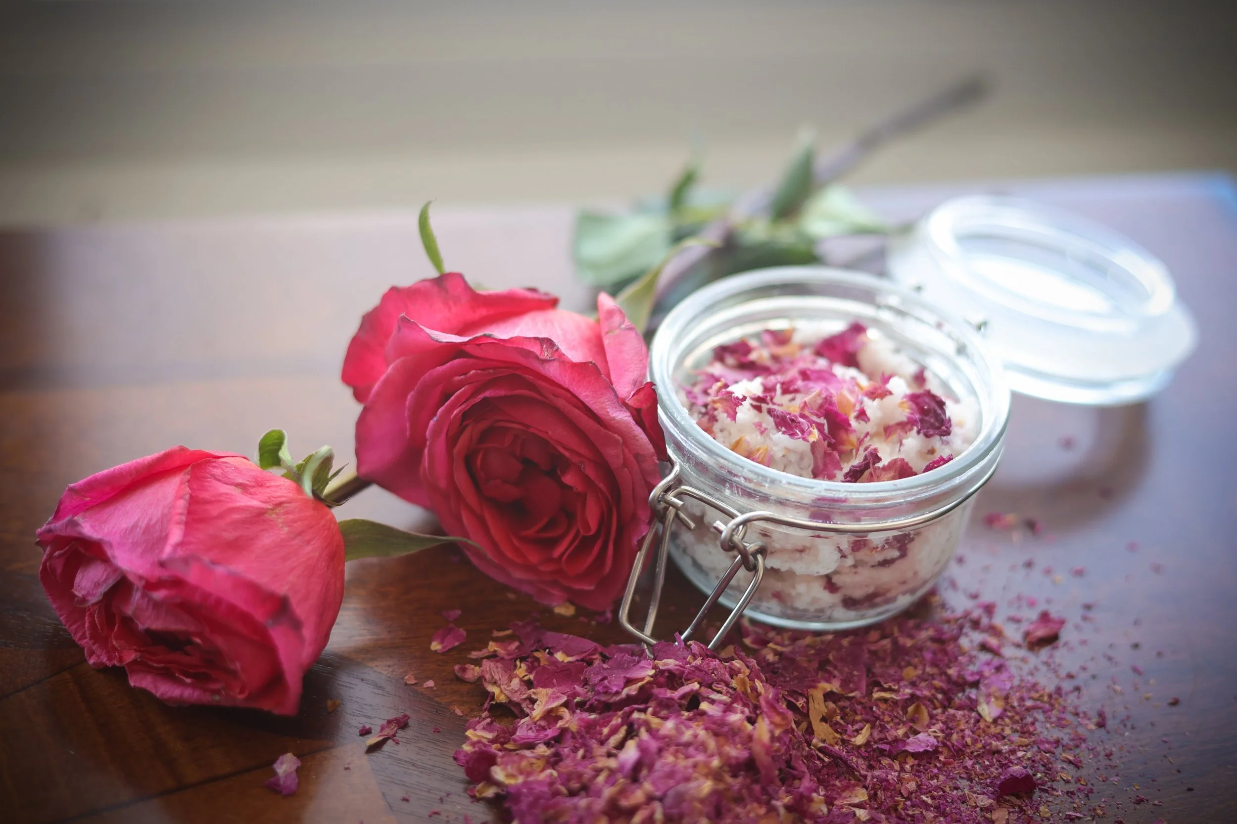 Roses, rose petals and jar of self made scrub