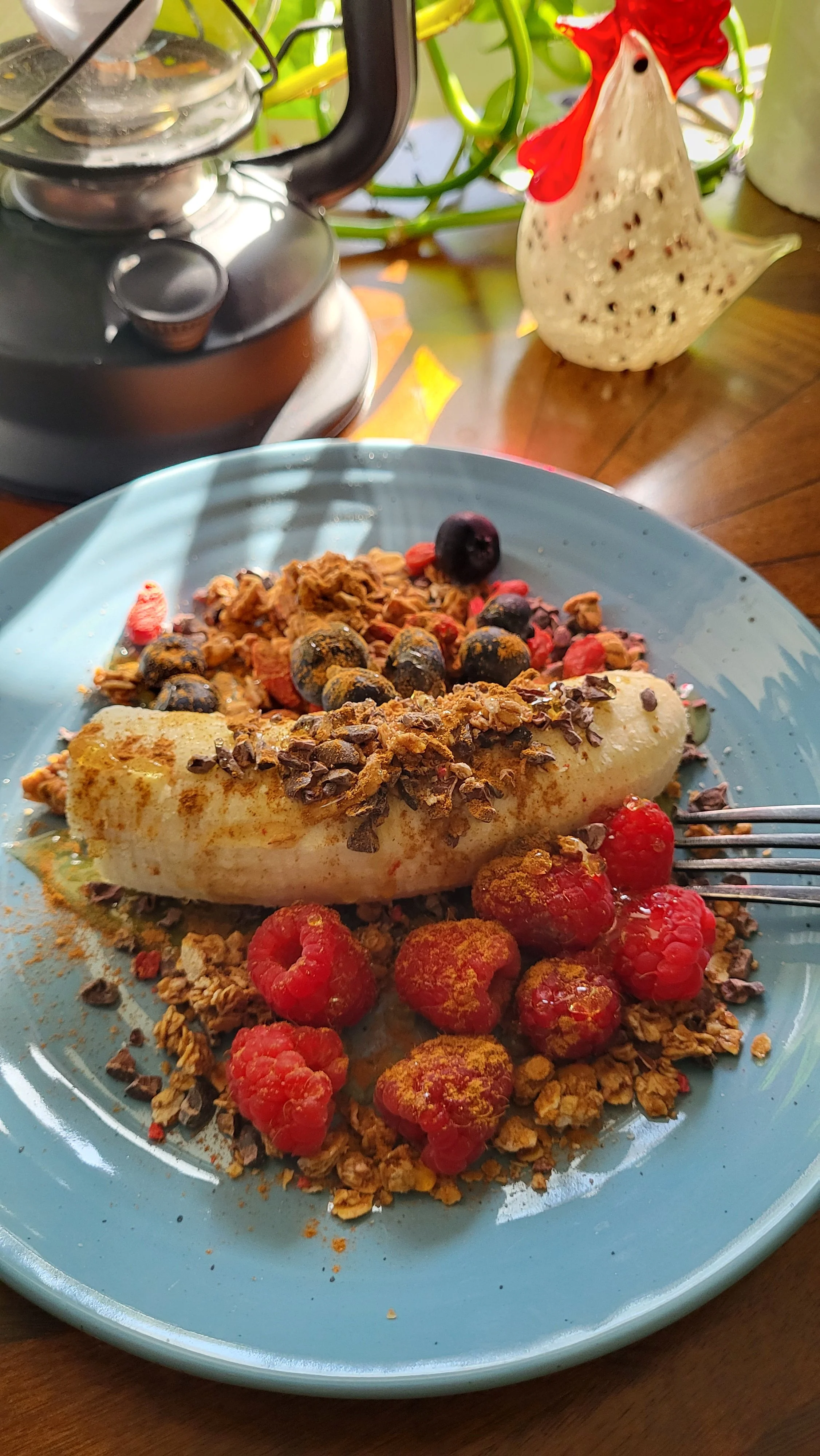 banana with raspberries, granola, honey and chocolate
