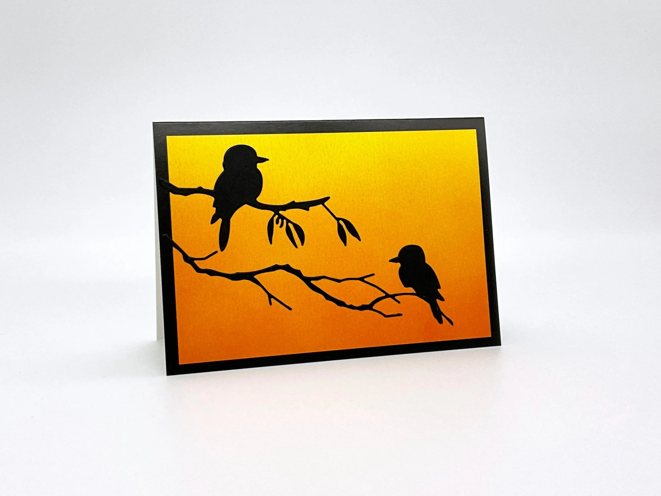 Two kookaburras on branch at sunset