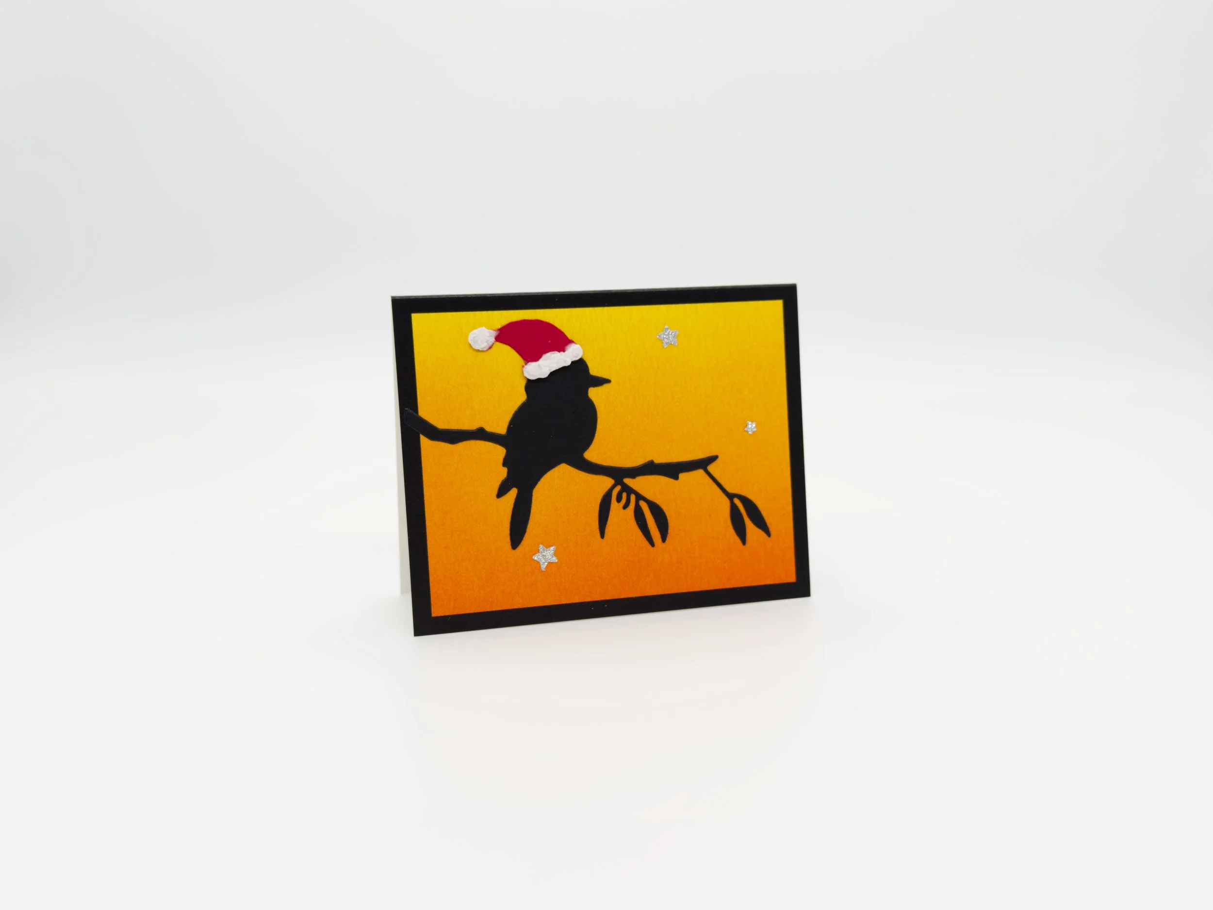 Kookaburra on branch with Santas hat at sunset christmas