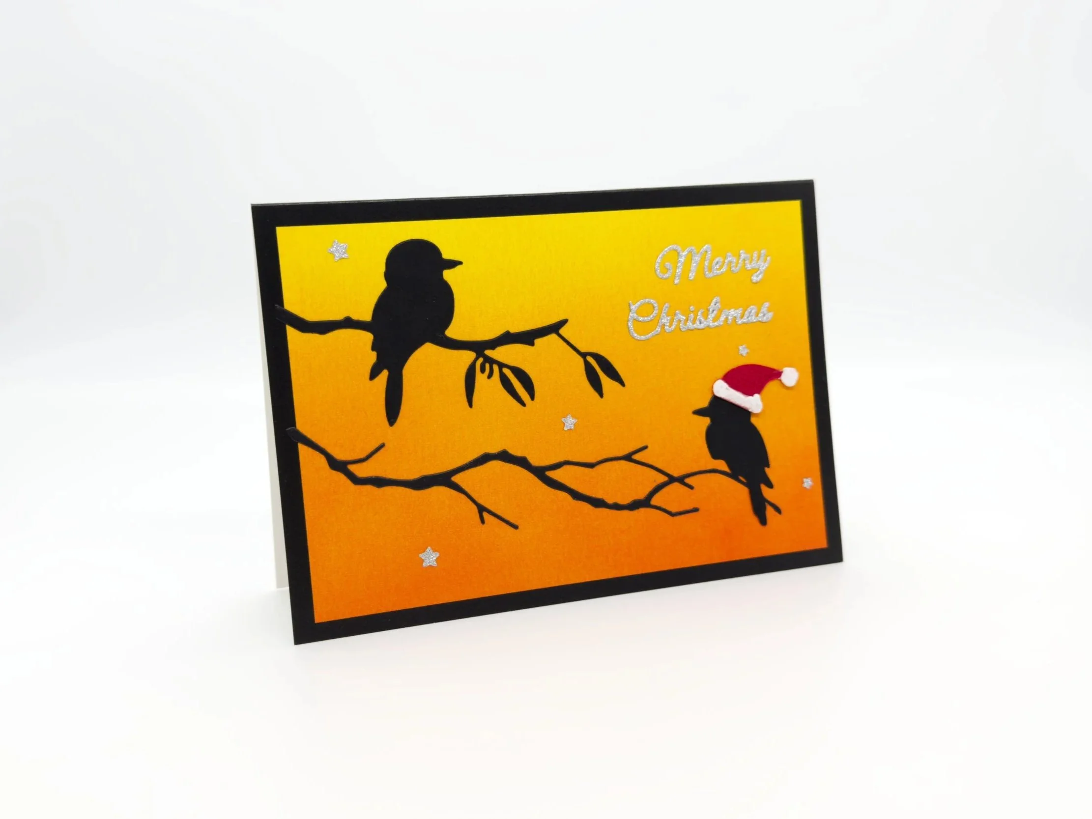 Two kookaburras on branch at sunset christmas