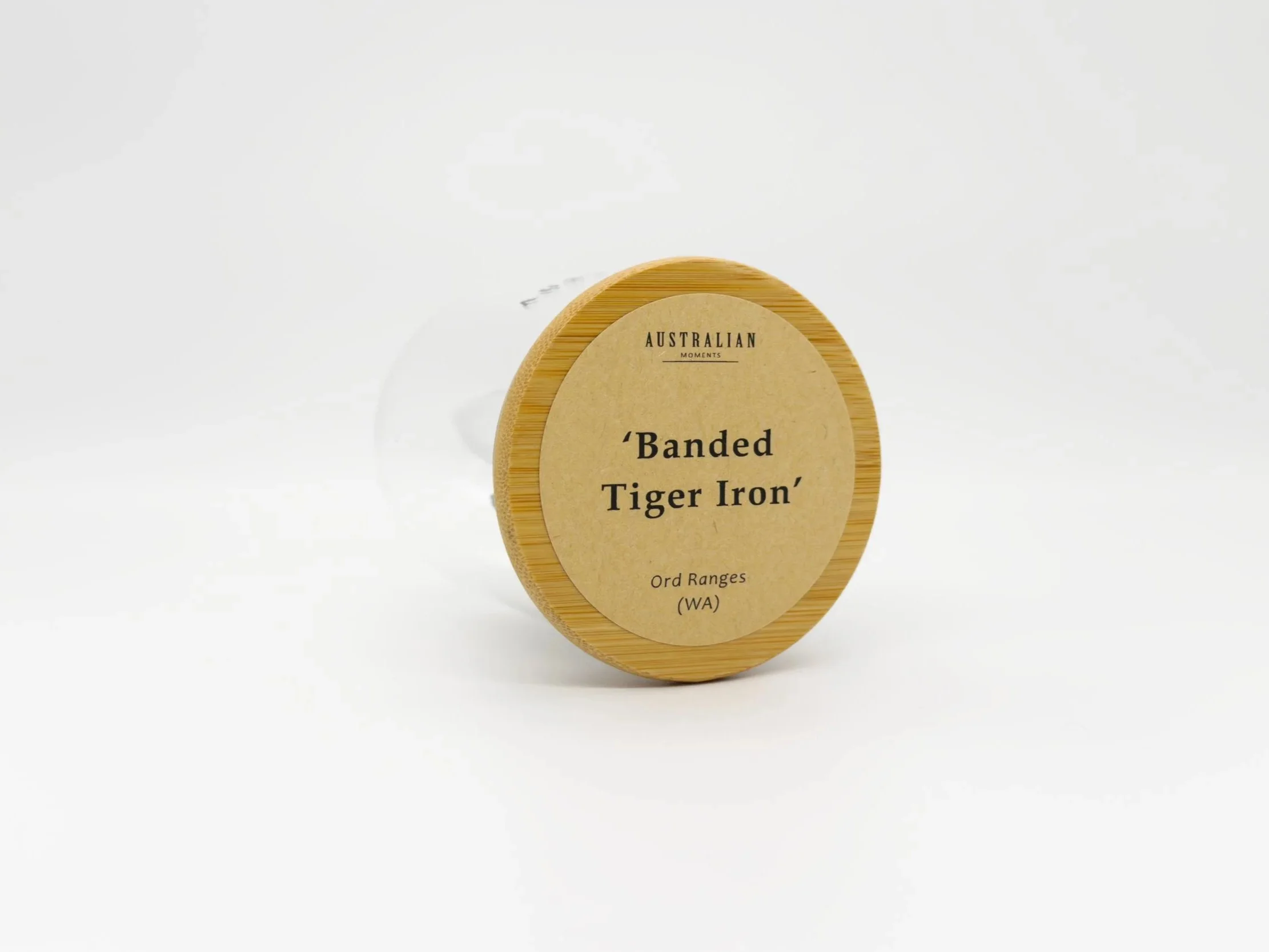 Banded tiger iron section in glass jar