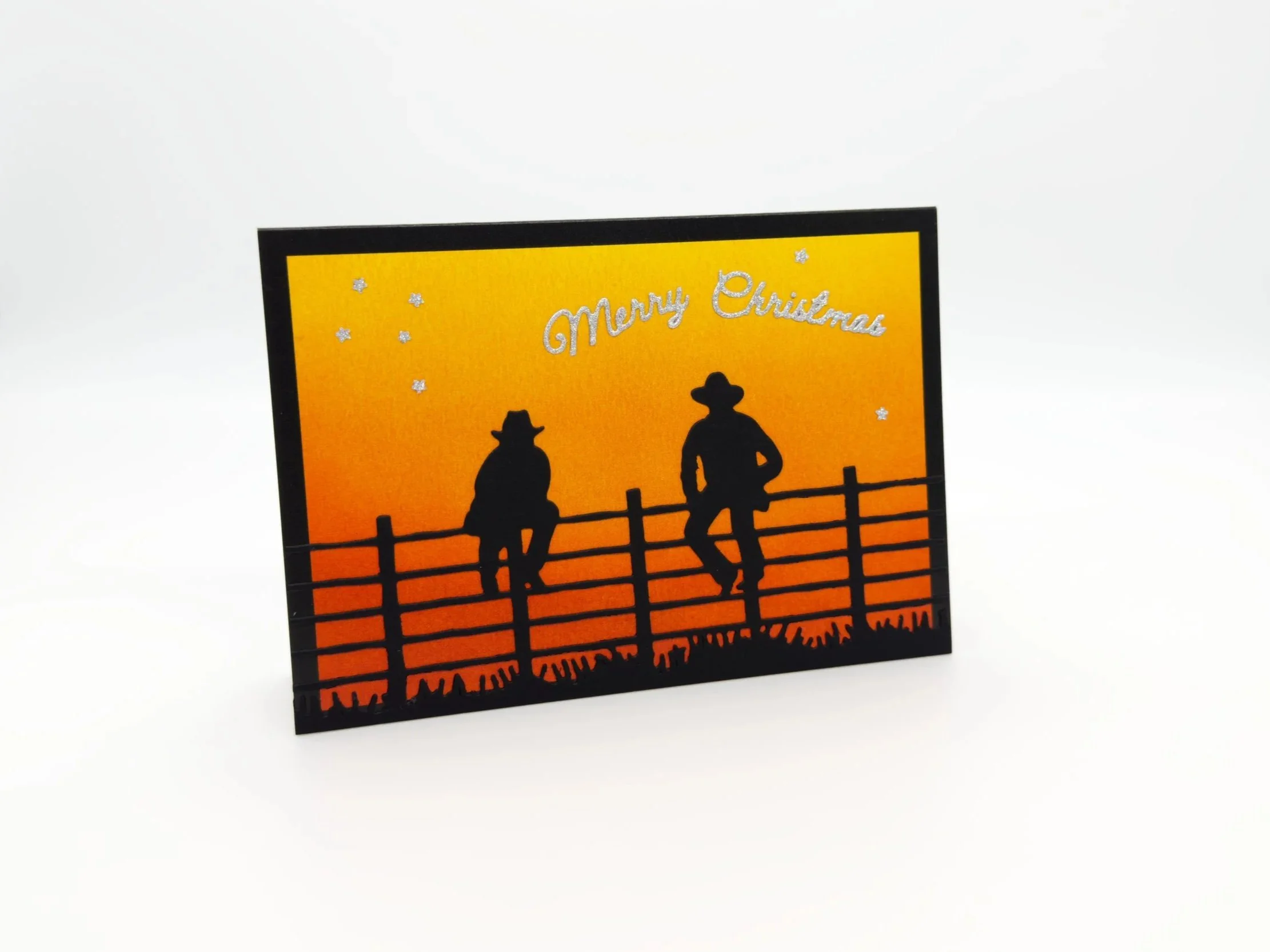 Station Hands sitting on fence at sunset christmas